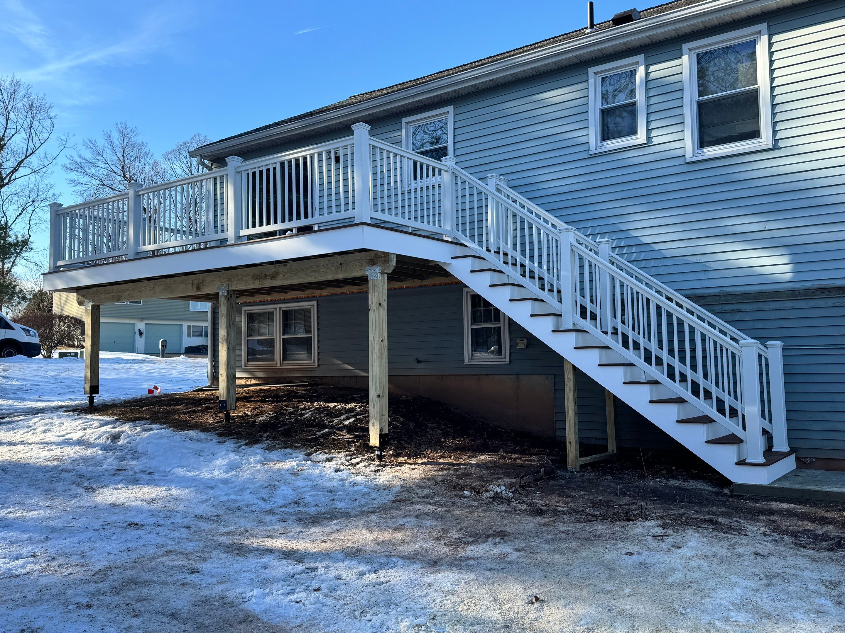 Deck replacement with Trex Select Saddle and White Select T rail. by DiGiorgi Roofing and Siding Inc