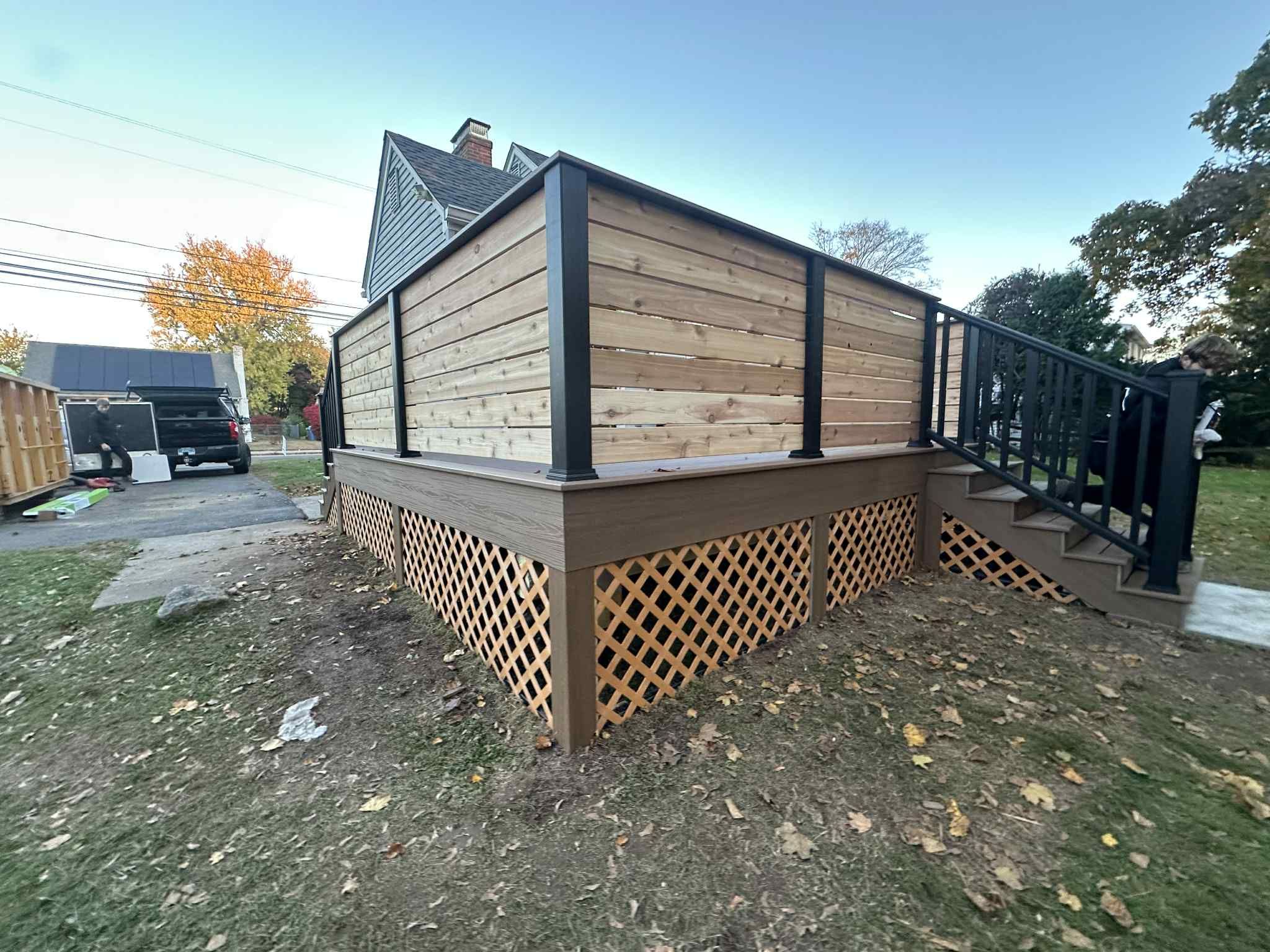 Deck Replacement with Trex Lineage Jasper, Custom Railings and Trex colored fascia by DiGiorgi Roofing and Siding Inc