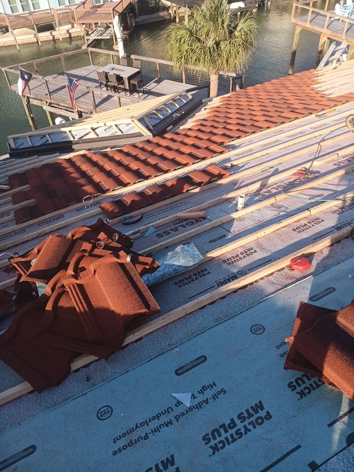 Off with the Tile and on with the TILCOR stone coated metal.  by Bayfront Roofing and Construction