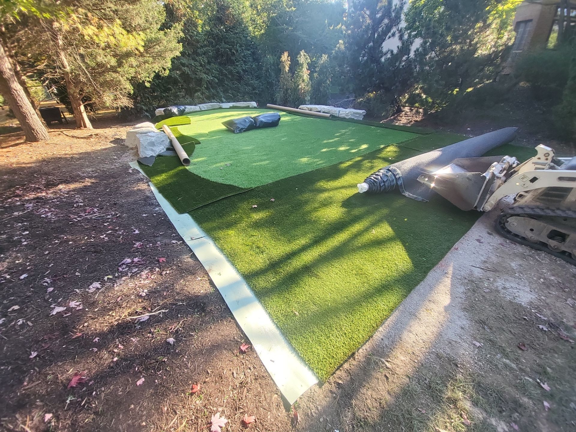 Custom Backyard Putting Green around Landscape Boulders in Hilliard by Southwest Greens Midwest