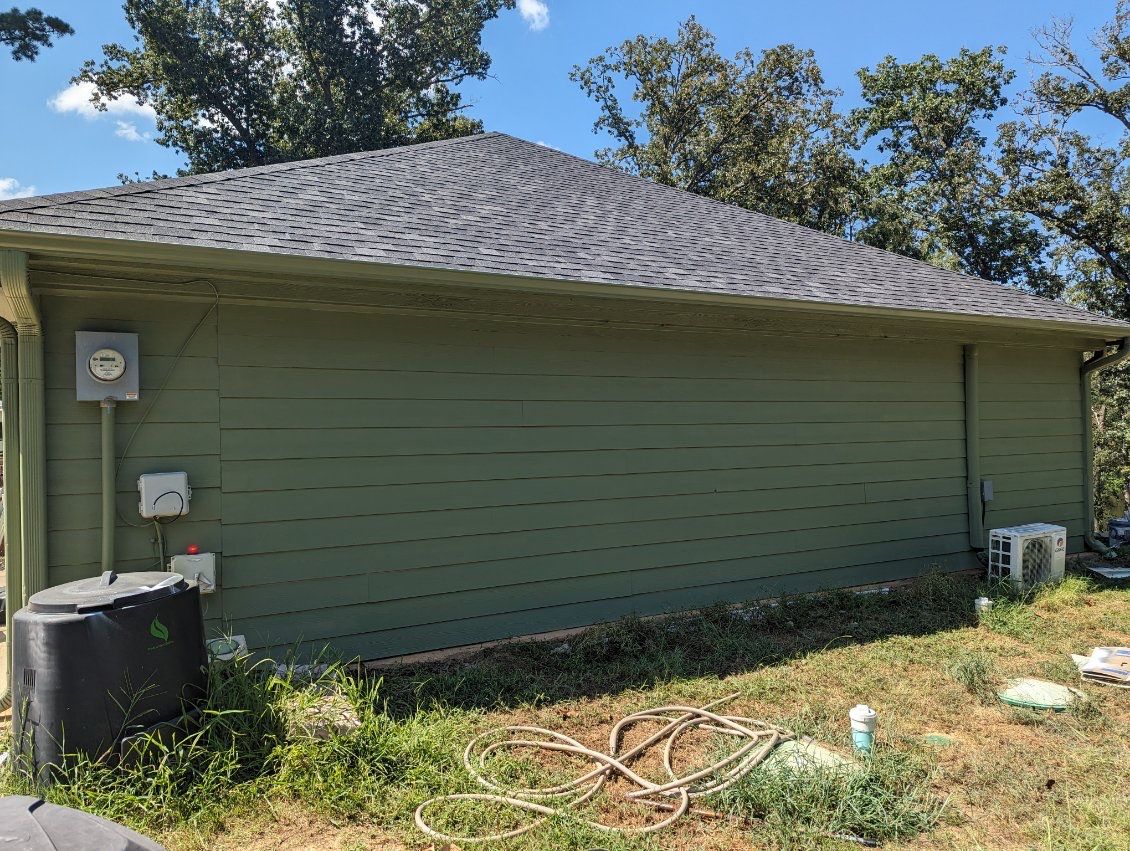 Exterior Repaint – Tyler, Texas - Bold green color with black garage by Quality Coats Painting