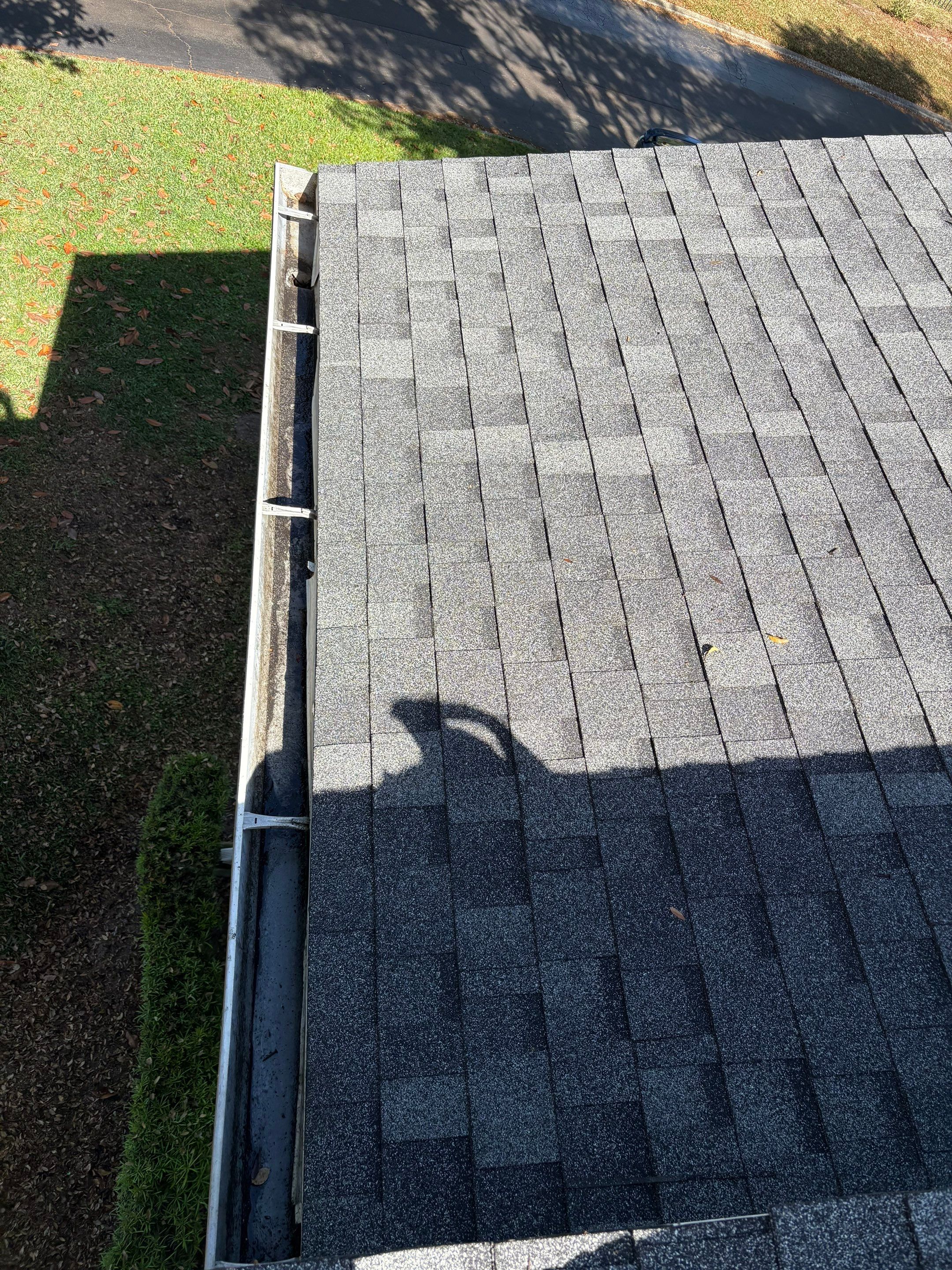 Gutter cleaning in Orlando, FL after photo showing roof line with cleared gutters.