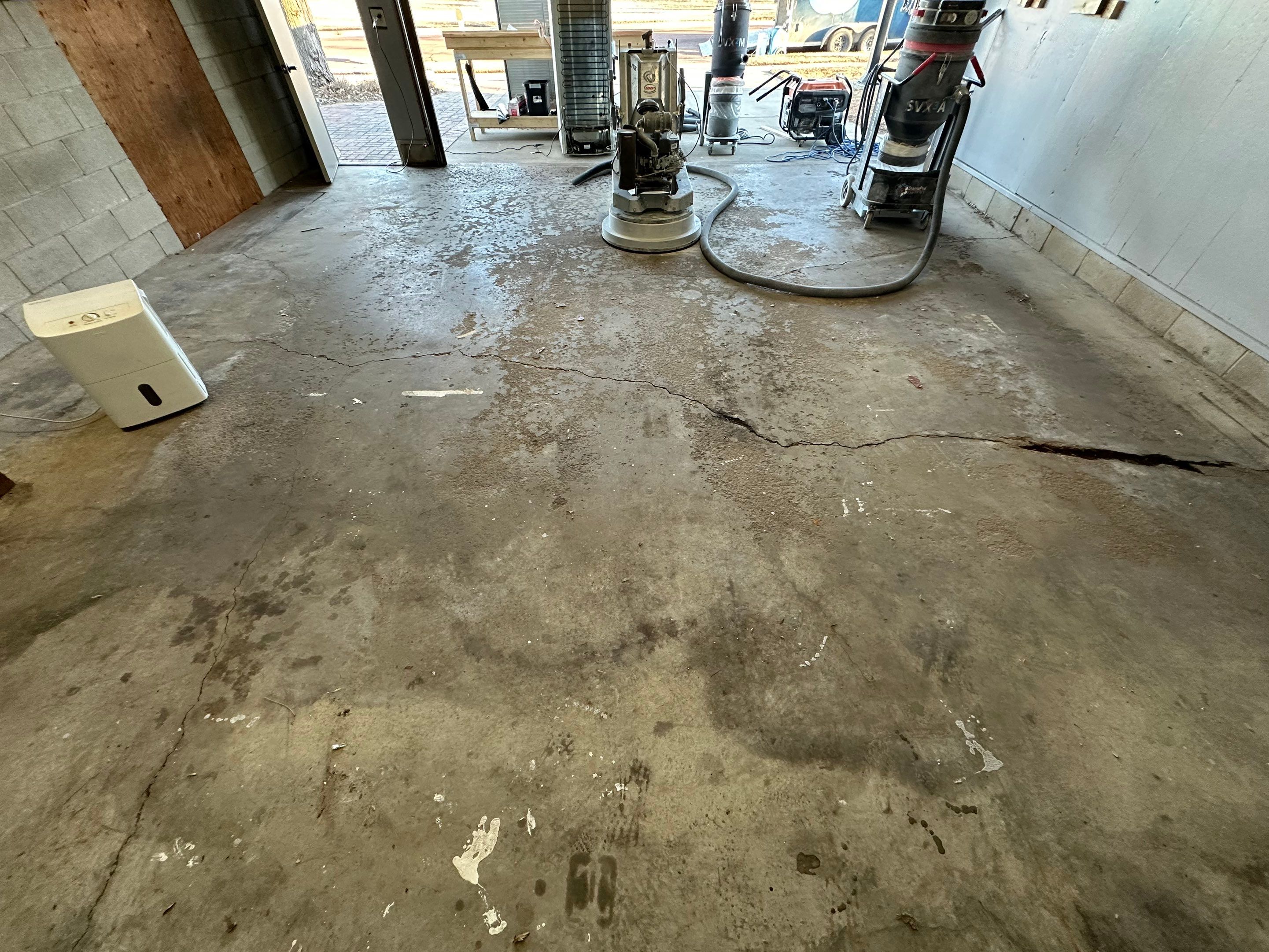 Multi-Colored Speckled Concrete Floor Coating Installation in Sioux Falls by Select Painting, Coatings & Garage Cabinets