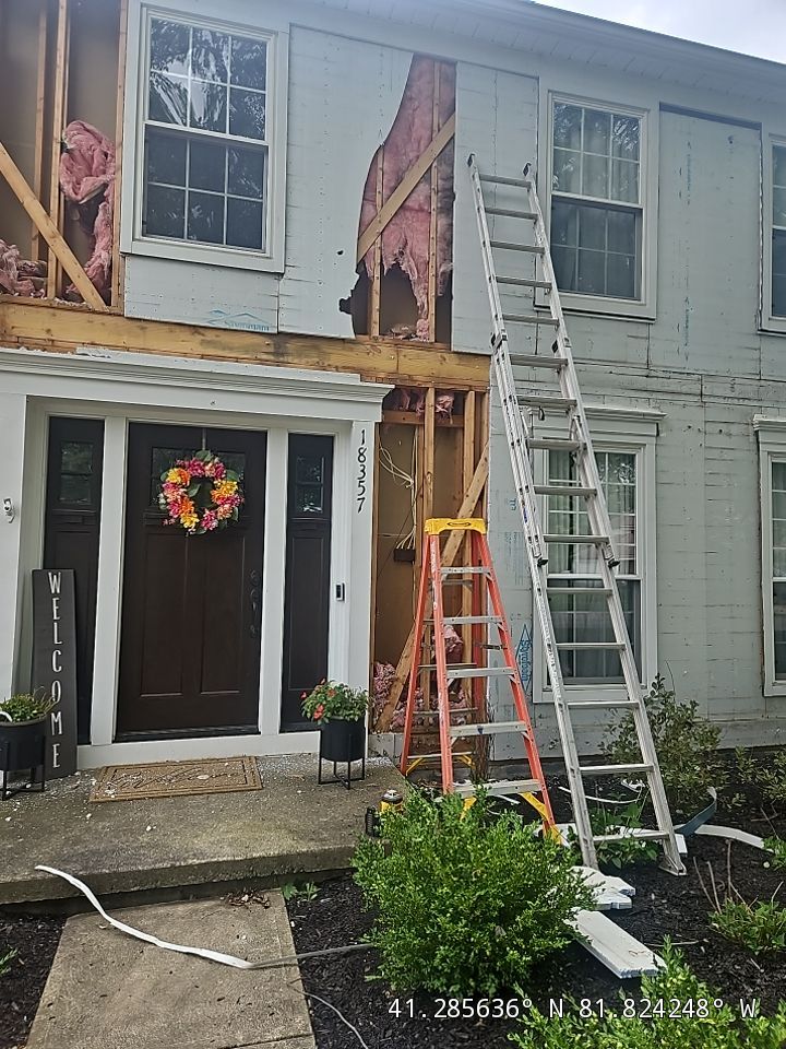 Vinyl Siding w. Stone Facade by Absolute Roofing and Construction