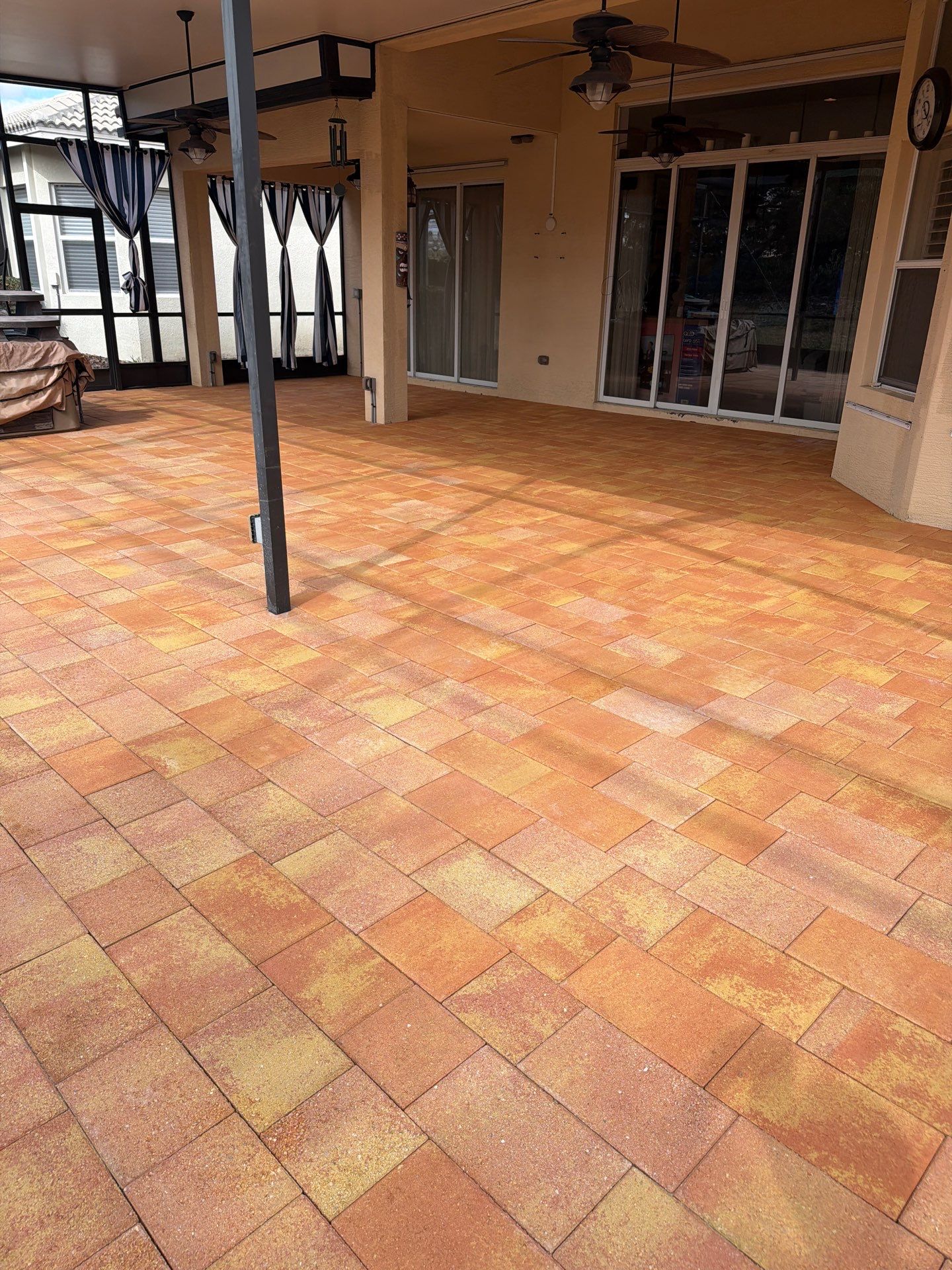 Paver Sealing for Herringbone Driveway and Screened Lanai in Valencia Lakes by Supreme Paver Experts