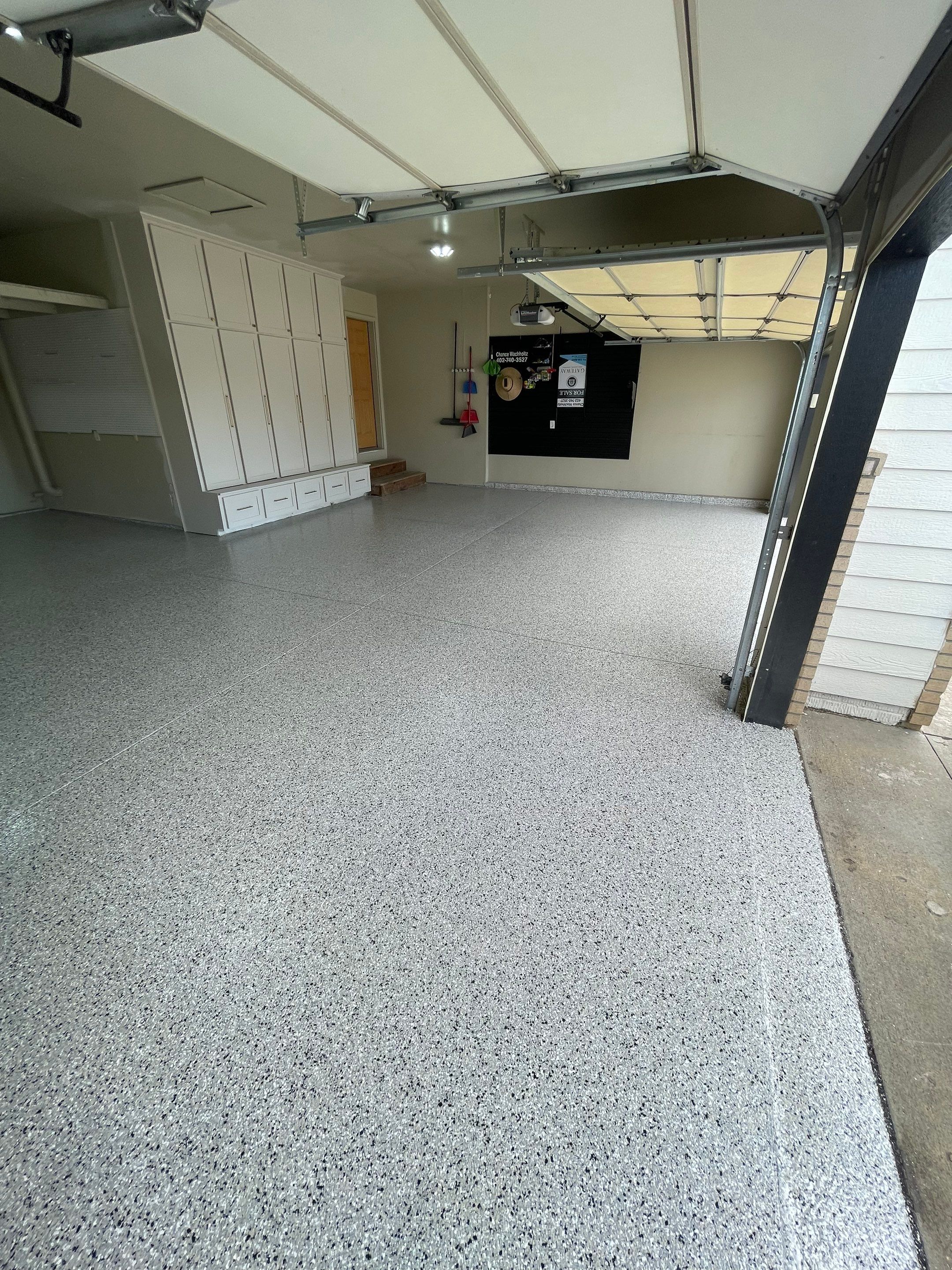 Cabin FEver Flake Garage Floor Coating Installation in Sioux Falls by Select Painting, Coatings & Garage Cabinets