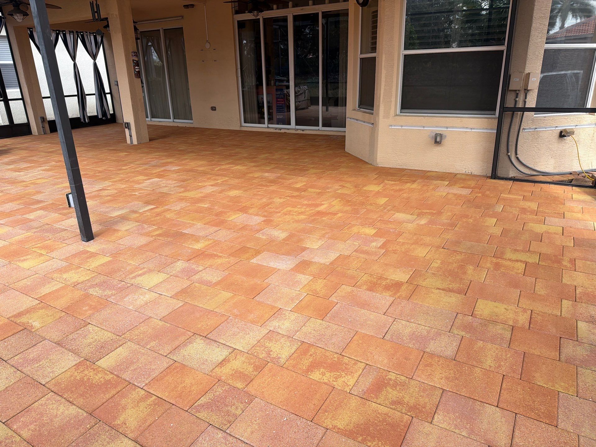 Paver Sealing for Herringbone Driveway and Screened Lanai in Valencia Lakes by Supreme Paver Experts