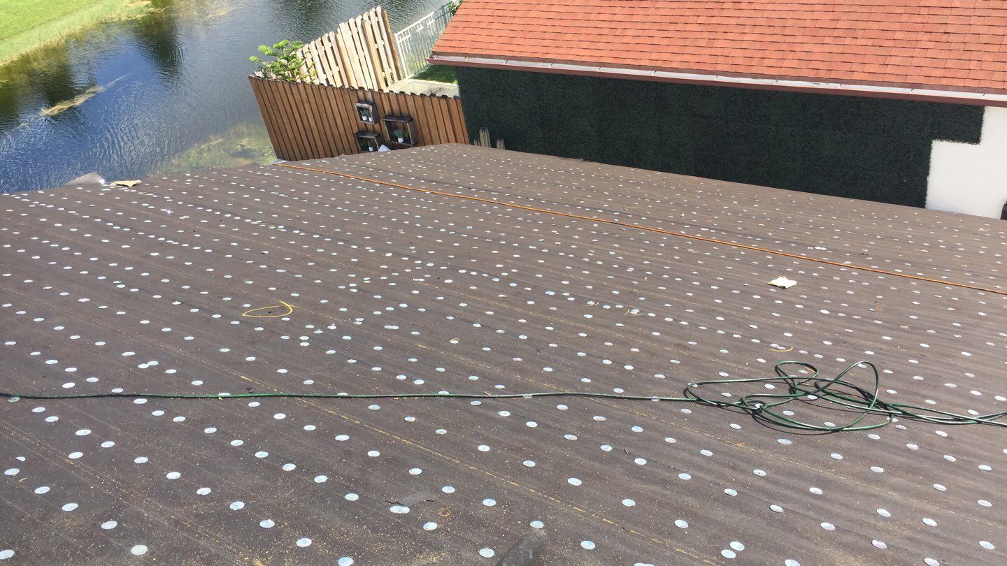 Residential Roofing Installation using 1" Nail strip metal roof by BLUES BROTHERS CONSTRUCTION CORP