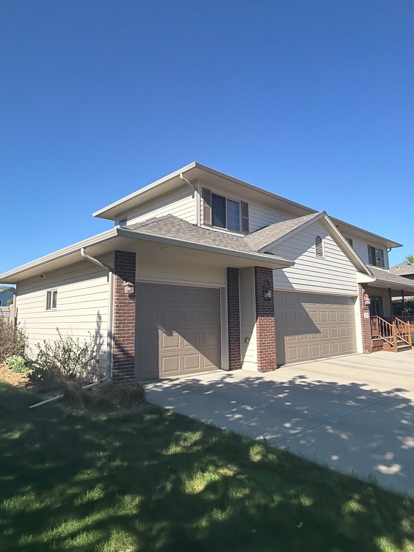 Residential Exterior Painting with Shutter and Trim Updates in Sioux Falls by Select Painting, Coatings & Garage Cabinets