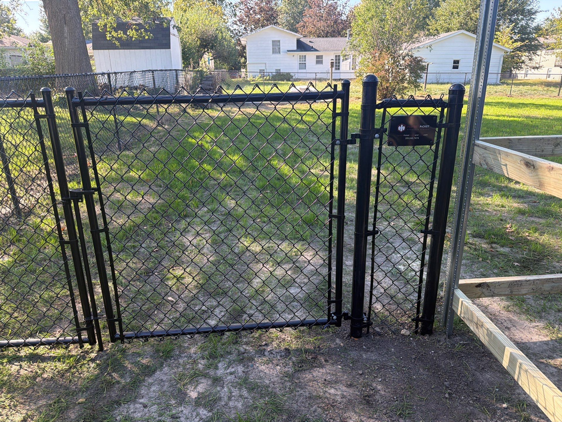 Black Chain Link Fence Installation with Double Gate in Cedar Falls by Perfect Picket Fence and Stain