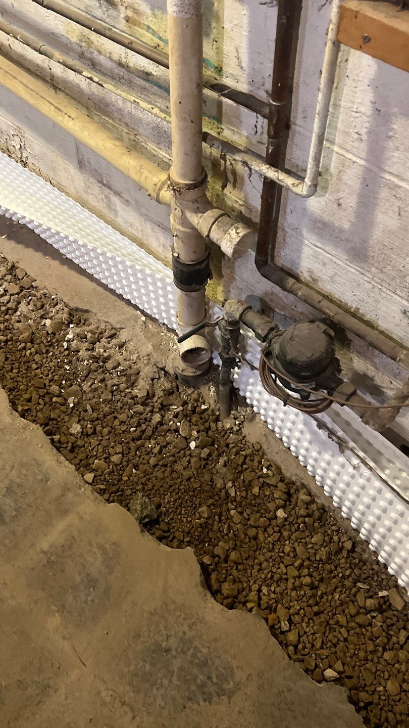 Interior drain tile system installation by ACE Waterproofing & Basement Solutions