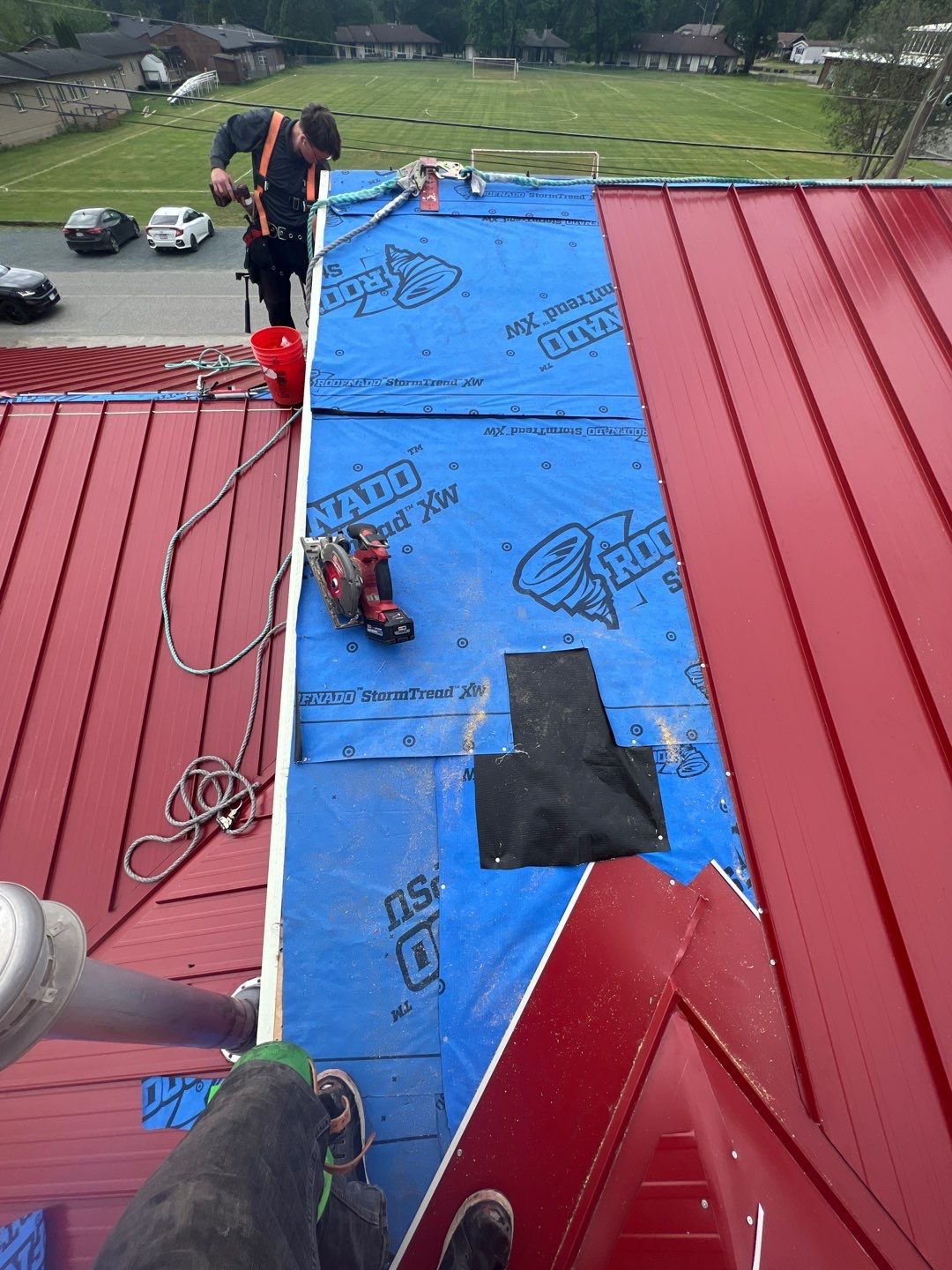 Commercial Roofing Installation using 12" Prolok metal  by Top Notch Roofing Inc