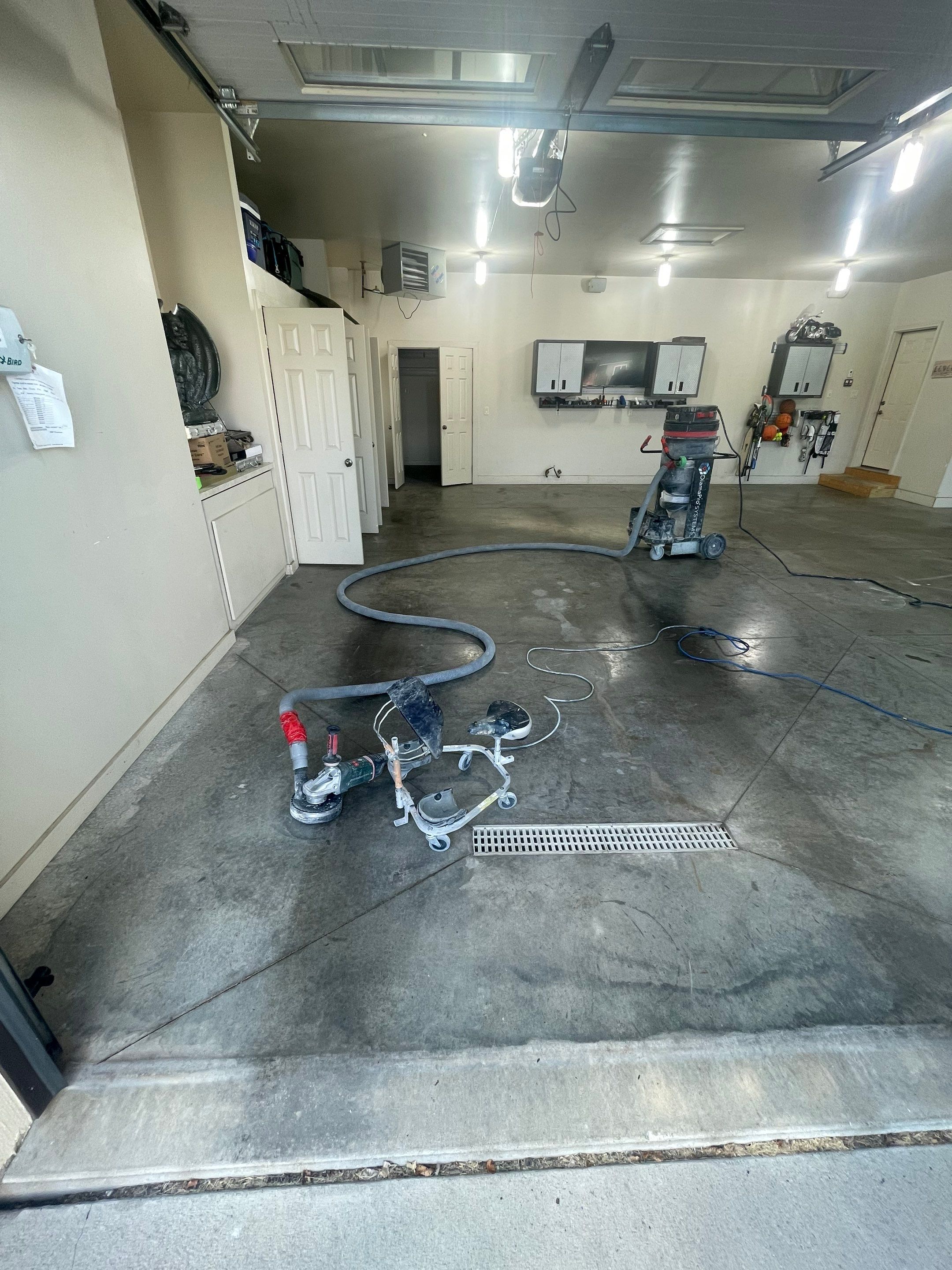 Coyote Flake Garage Floor Coating in Sioux Falls with Trench Drain by Select Painting, Coatings & Garage Cabinets