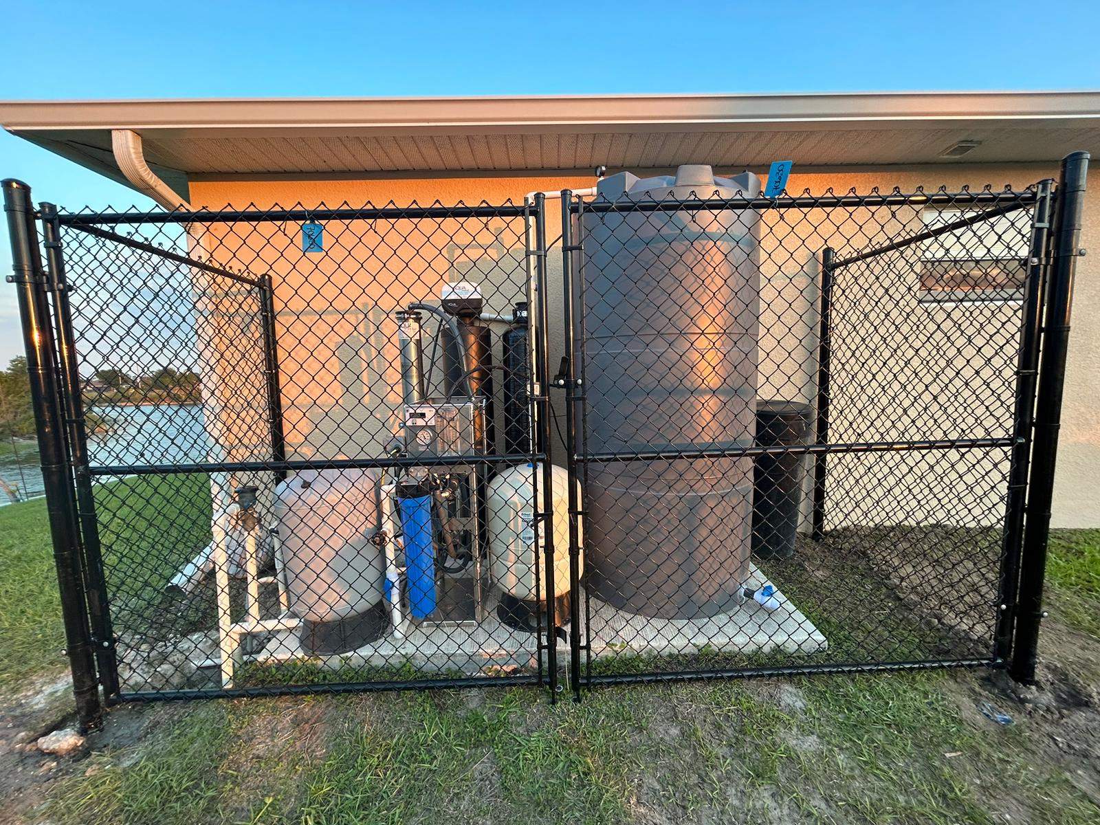 Black Chain Link Perimeter Fence and Utility Enclosure in Cape Coral by True Fence LLC