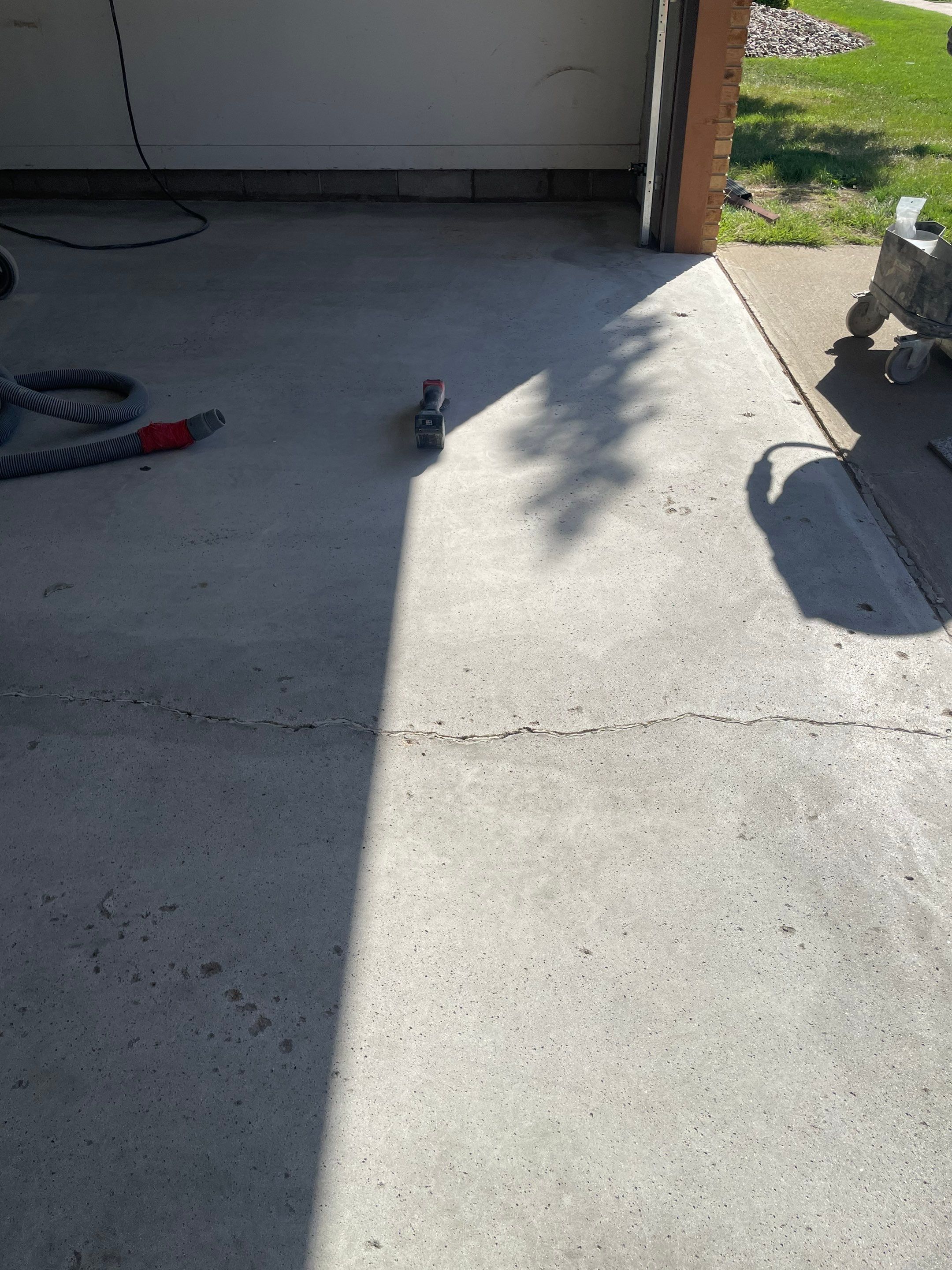 Grey Speckled Concrete Coating for Residential Garage in Yankton by Select Painting, Coatings & Garage Cabinets