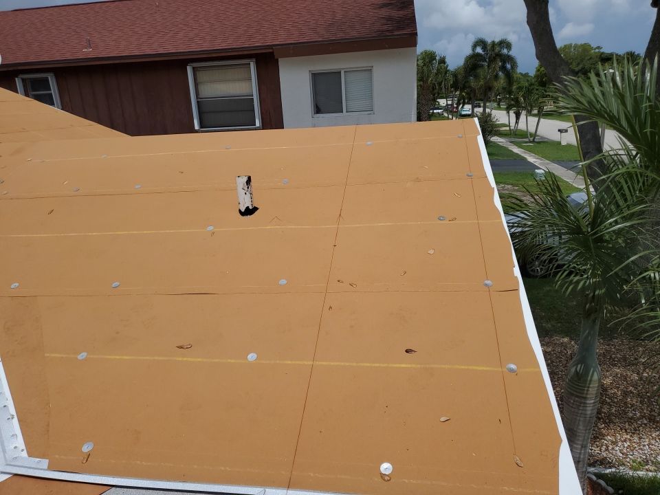 Residential Roofing Installation using 1.5" Nail Strip 24ga Solar White Kynar Coated Standing Seam Metal Panels by Morton Roofing, Inc.