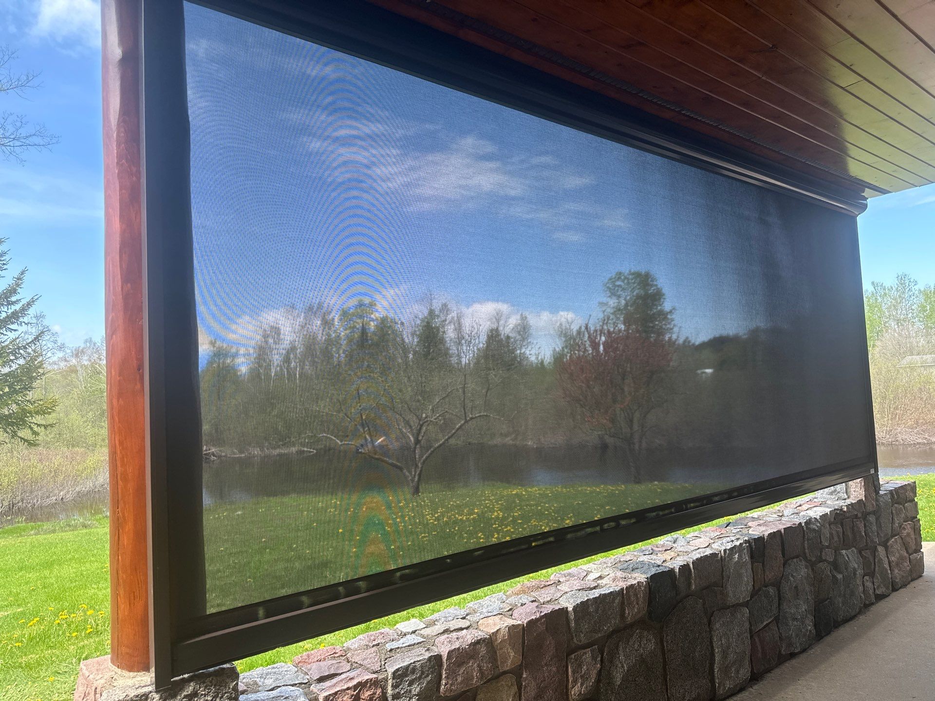 Sunesta Retractable Screen Installation on a Petoskey Log Home Porch by Rainbow Seamless Systems