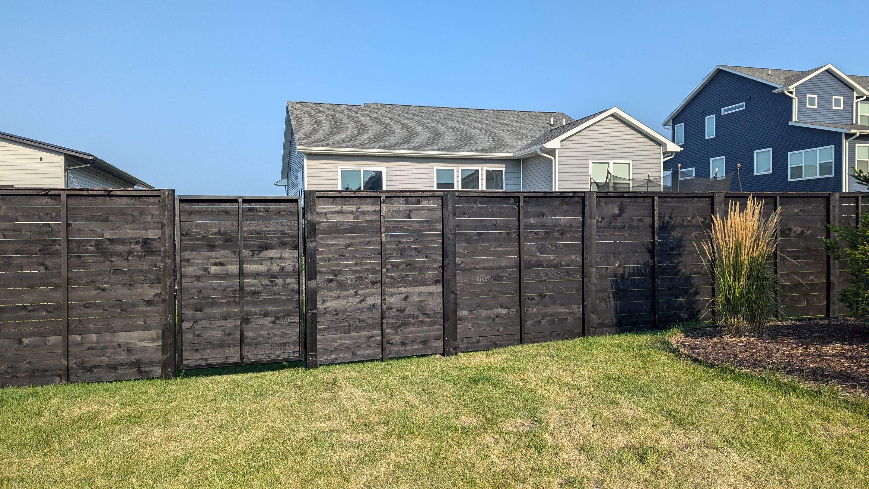 Modern Black Stained Horizontal Privacy Fence Installation in Cedar by Perfect Picket Fence and Stain