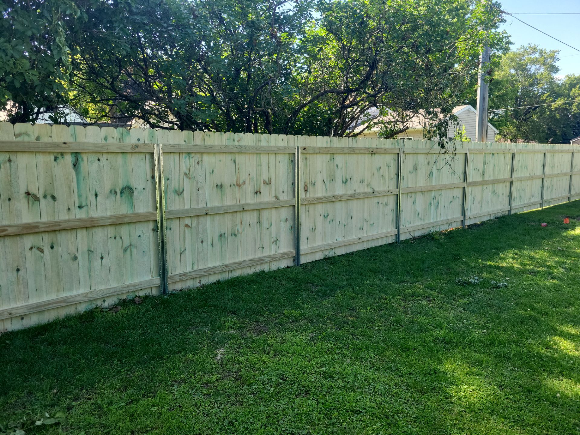 Pressure-Treated Wood Privacy Fence Installation in Charles City by Perfect Picket Fence and Stain
