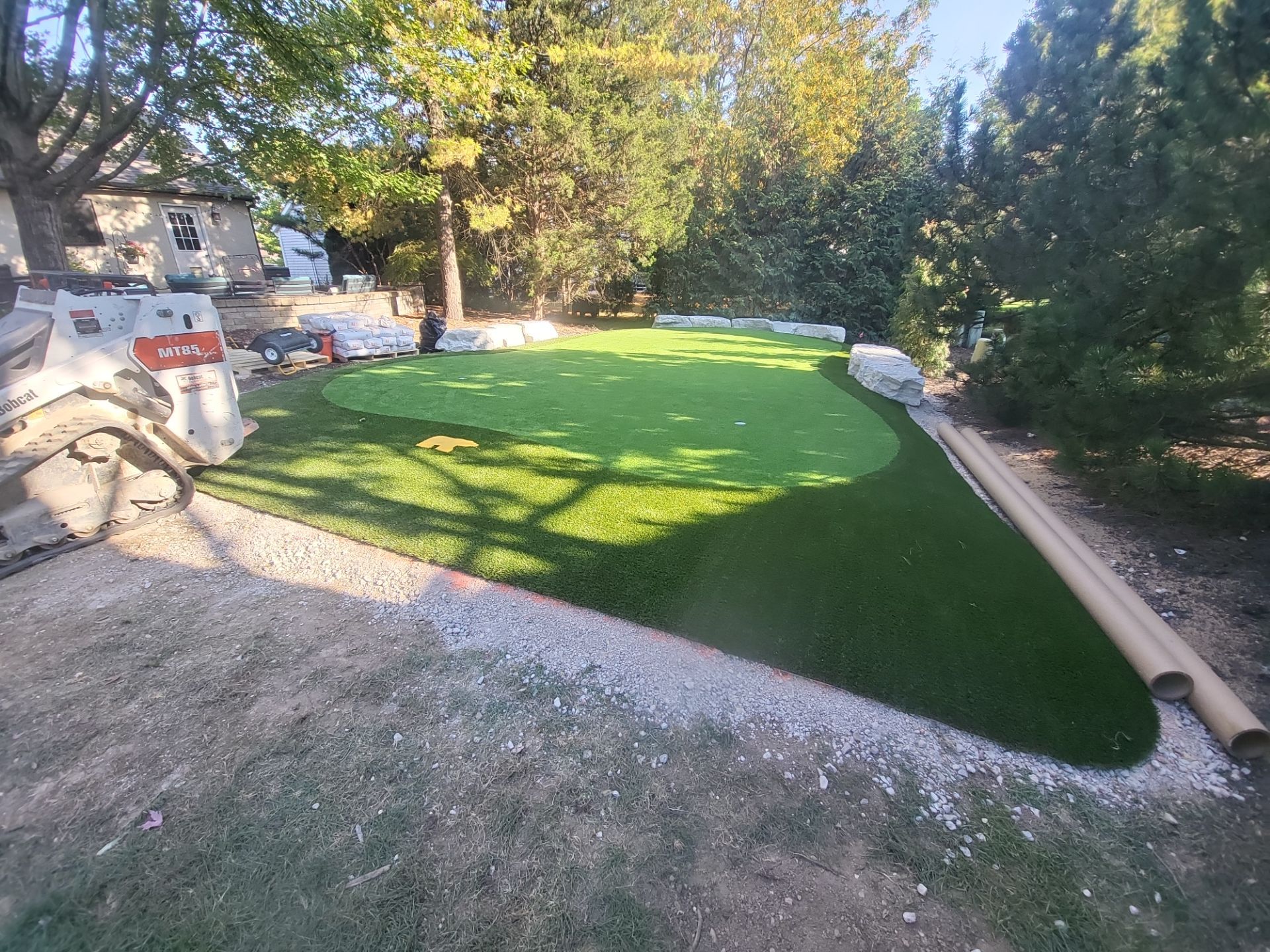 Custom Backyard Putting Green around Landscape Boulders in Hilliard by Southwest Greens Midwest