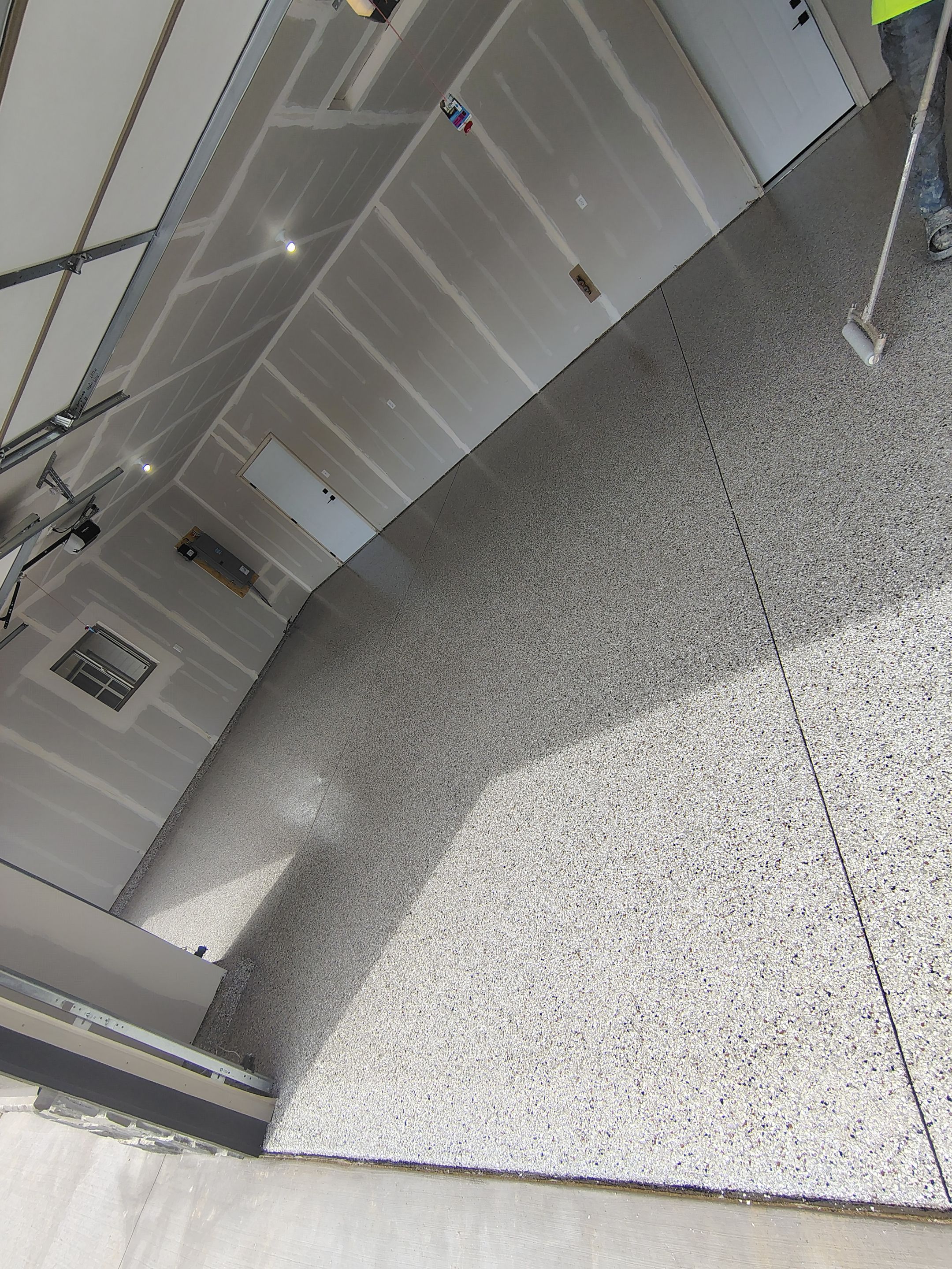 Speckled Epoxy Garage Floor Coating Installation in Sioux Falls by Select Painting, Coatings & Garage Cabinets