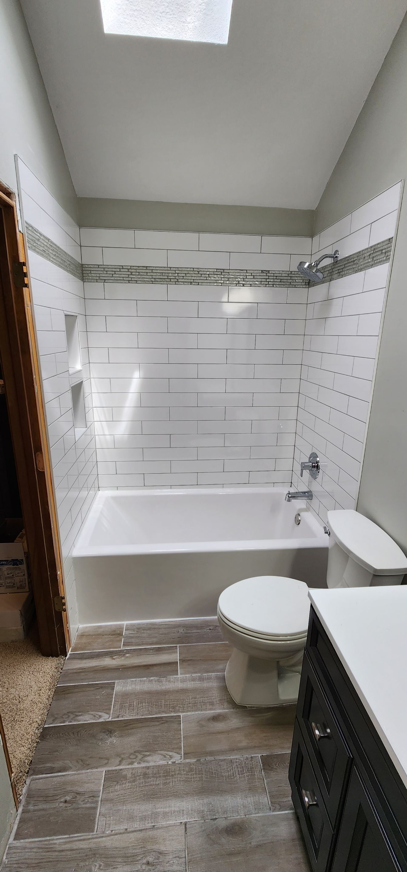 Beautiful tile tub surround and tile floors! Customer started, TSC finished by The Shower Company