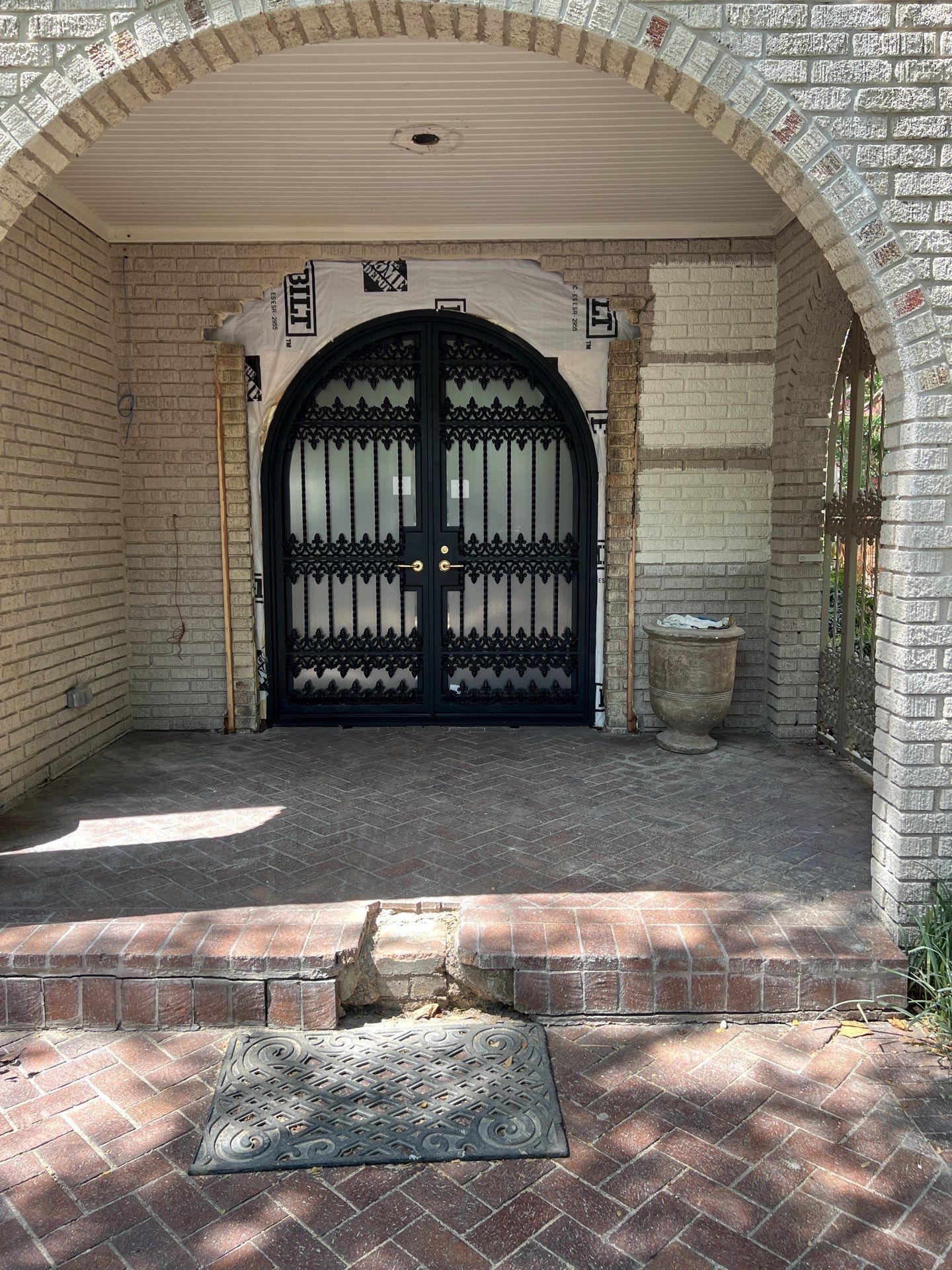 Custom Arched Black Wrought Iron Double Door Installation in Dallas by Solara Custom Living