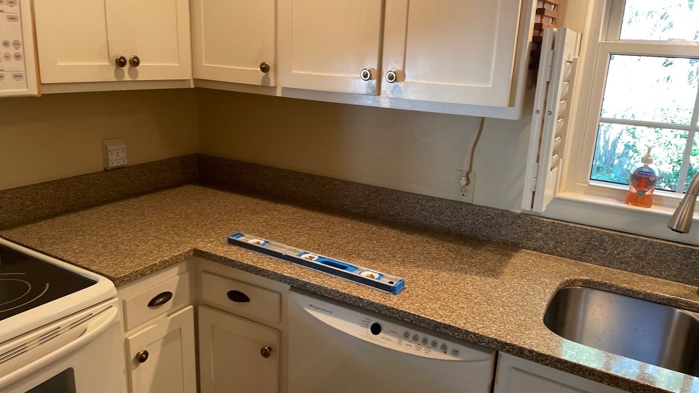New Backsplash to Compliment the Countertops by Footprints Floors of Coastal Carolina