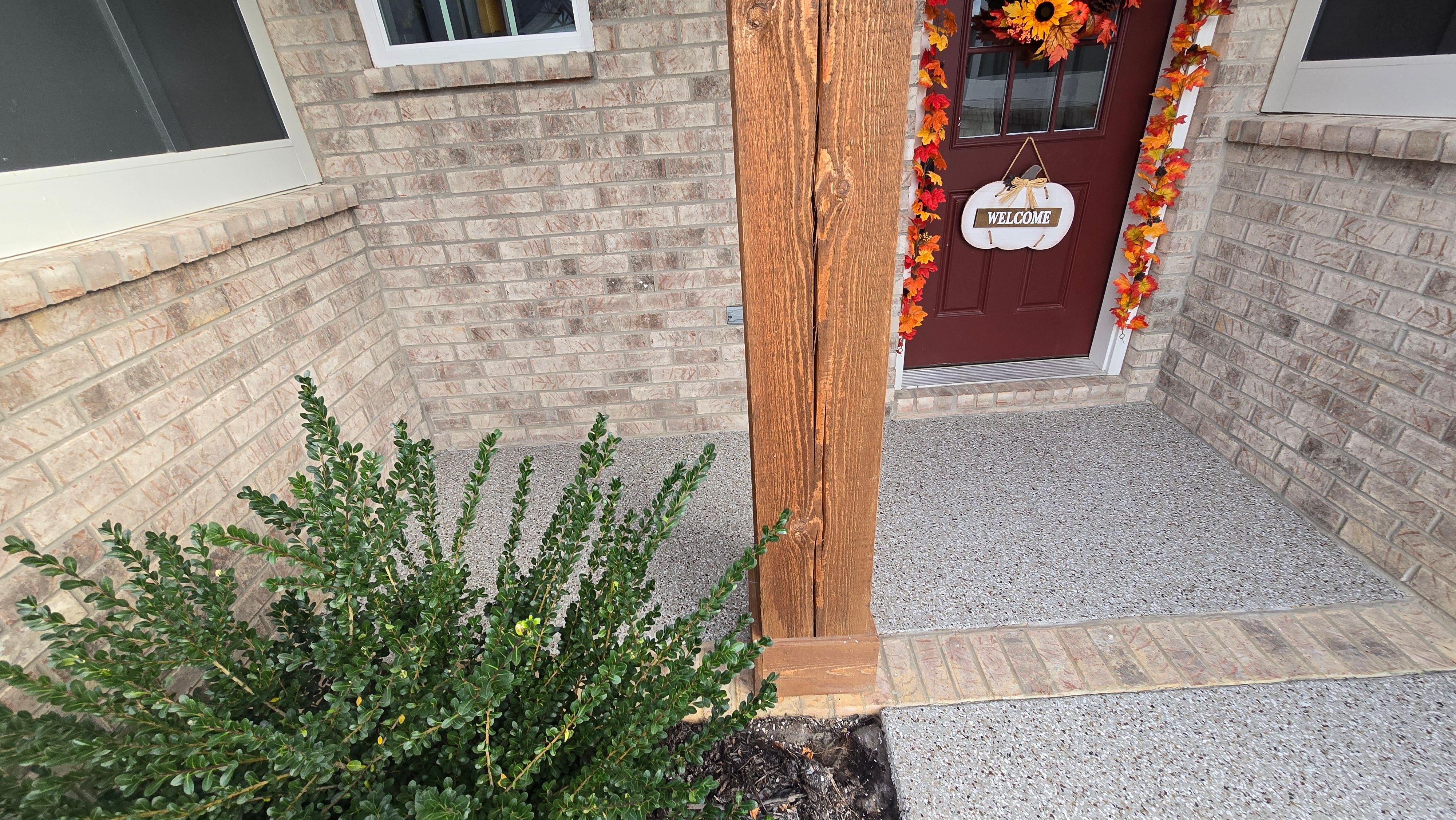 Sidewalk, Porch, and Back Patio Using Creekbed and Nordic Green by Elite Floor Solutions