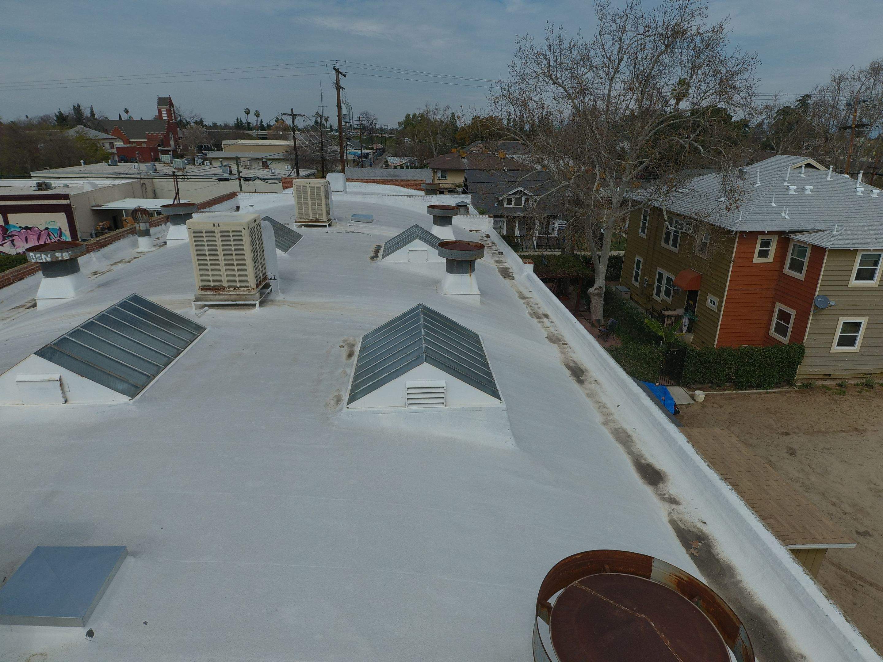 Polyurethane foam roof refurbish and recoating by Straight Edge Roofing Inc