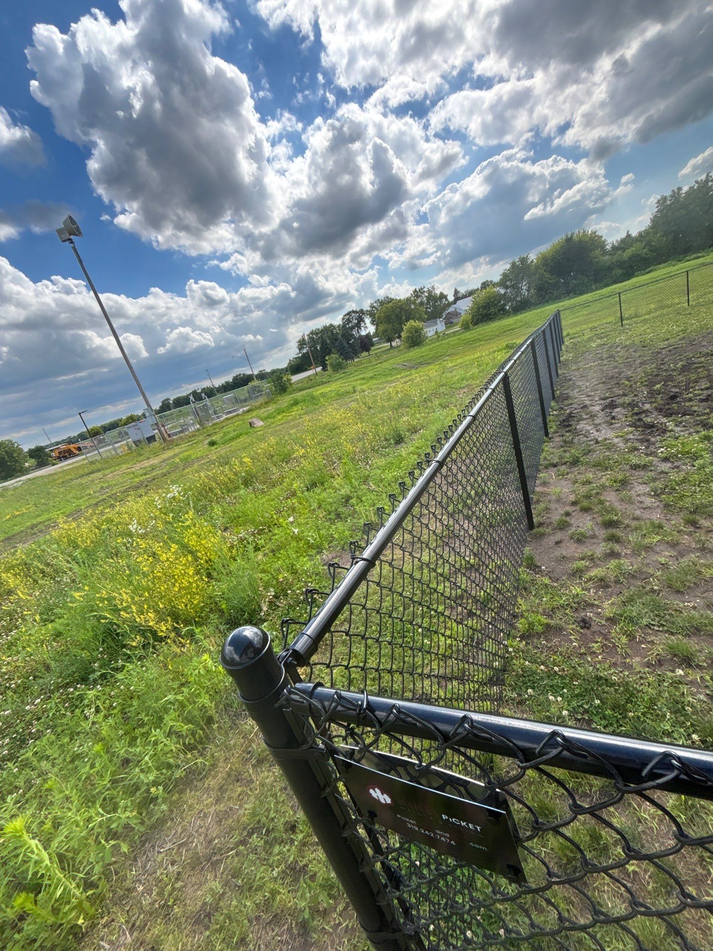 Black Vinyl-Coated Chain Link Fence and Residential Site Grading by Perfect Picket Fence and Stain