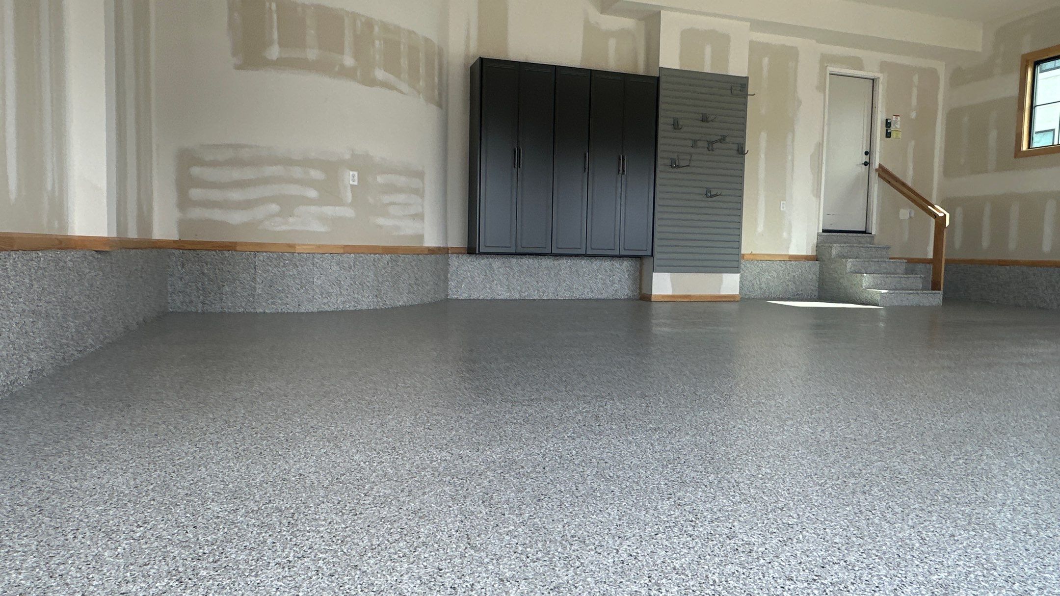 Megan J. added cabinets and slotwall to her garage. Plus a New Floor by Banner Garage