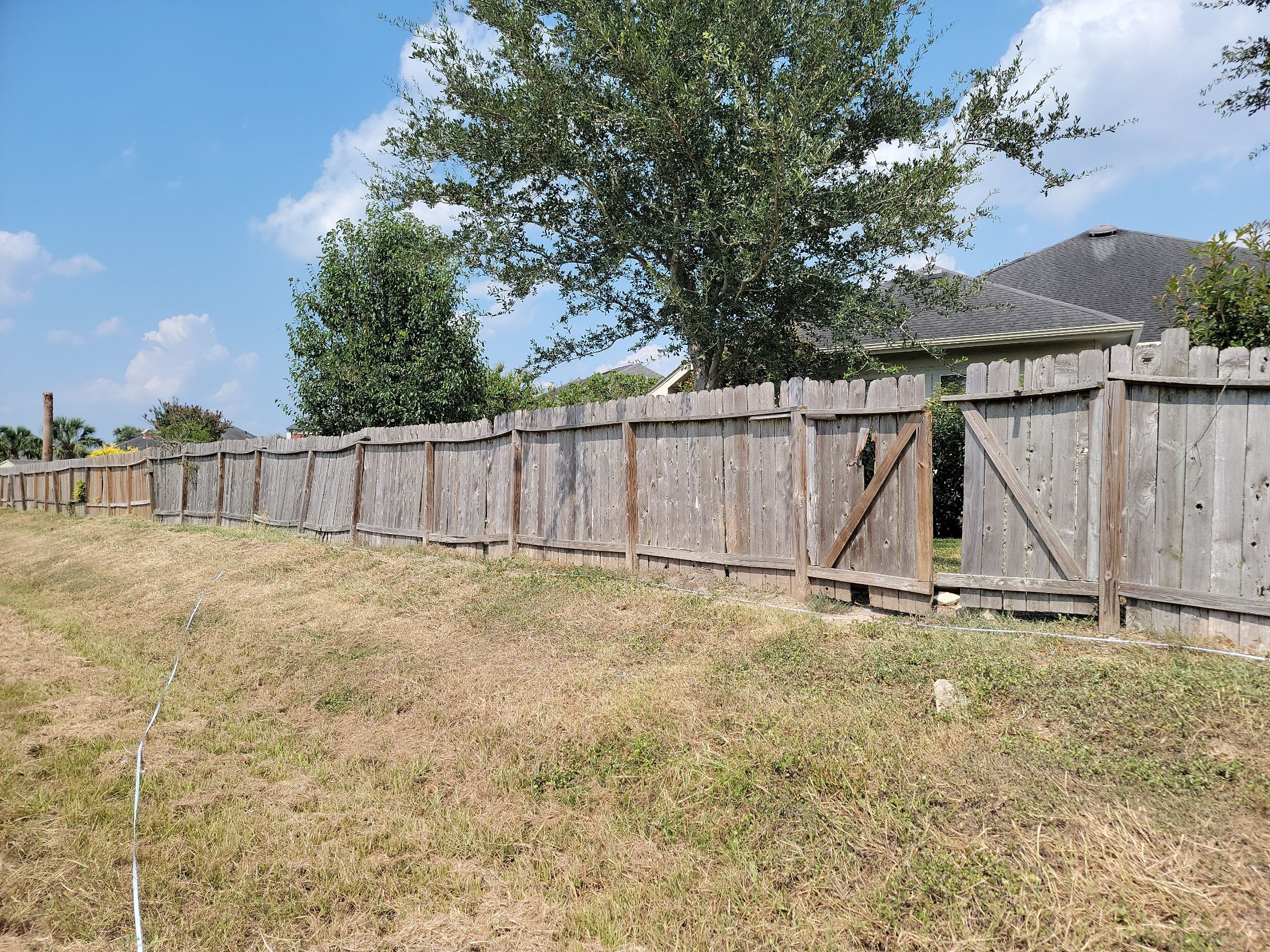 Beautiful Wood fence with metal posts by Tim's Fences