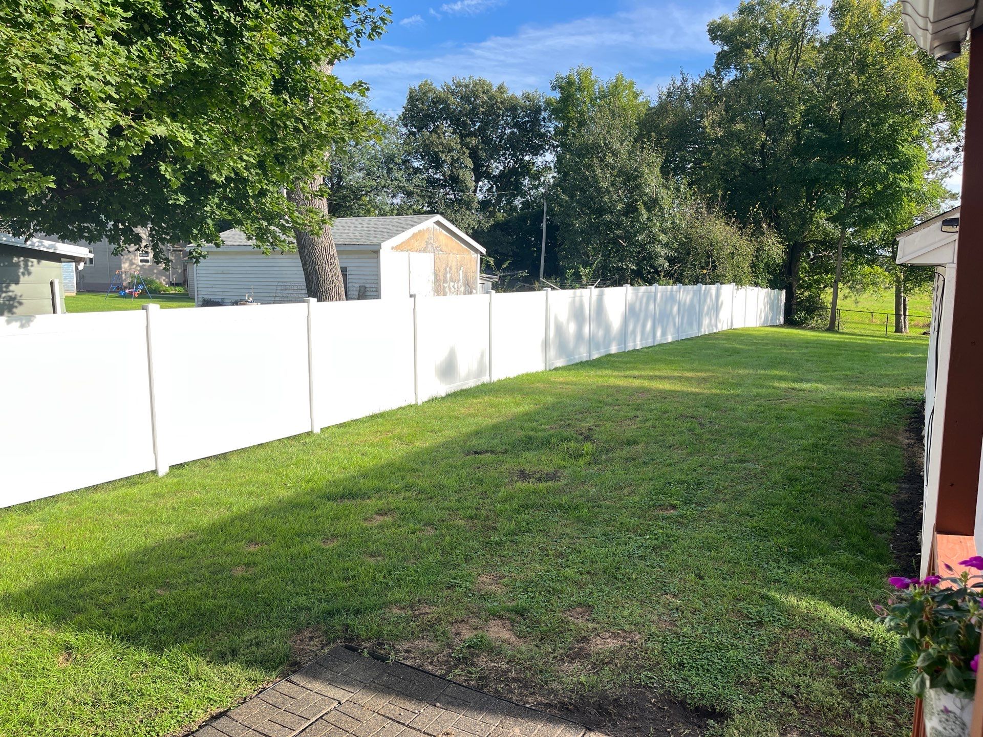 White Vinyl Privacy Fence and Black Chain Link Installation in Sumner by Perfect Picket Fence and Stain