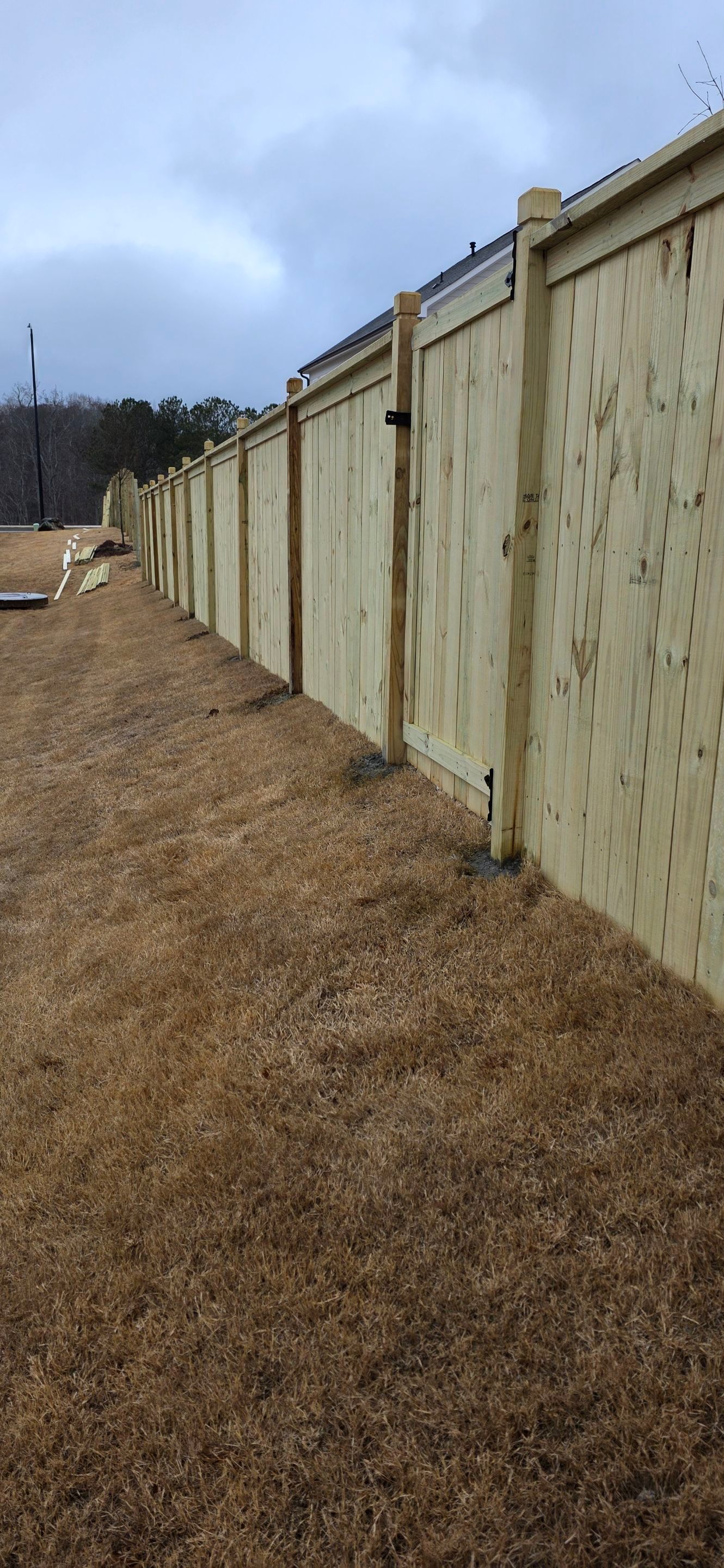 Fence Installation of Capped Wood Privacy with dado cut posts by Titans of Timber Fence & Stain