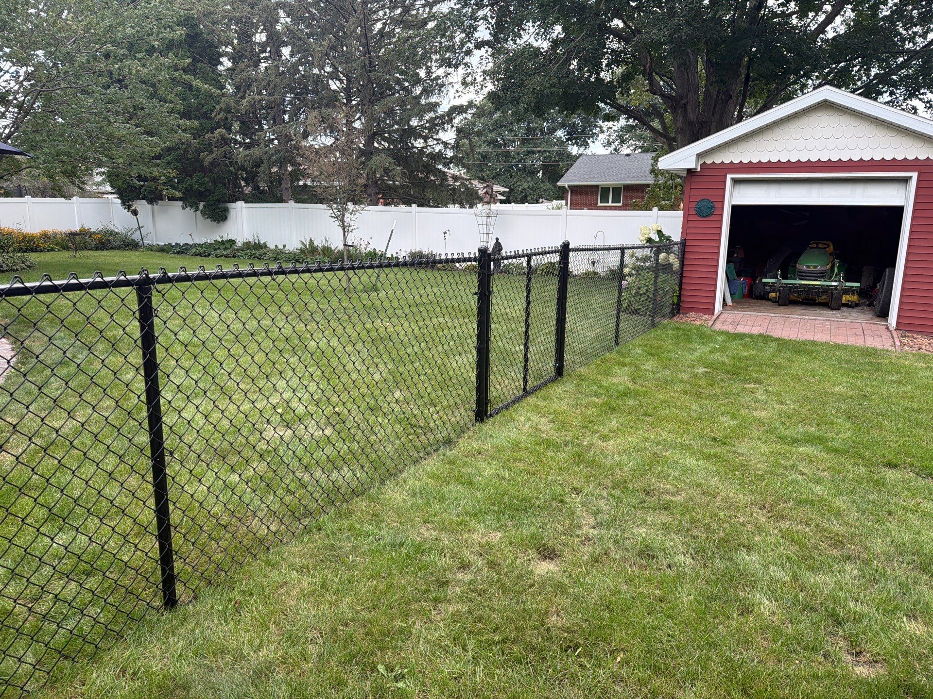 Residential White Vinyl Privacy and Black Chain Link Fencing in Jesup by Perfect Picket Fence and Stain
