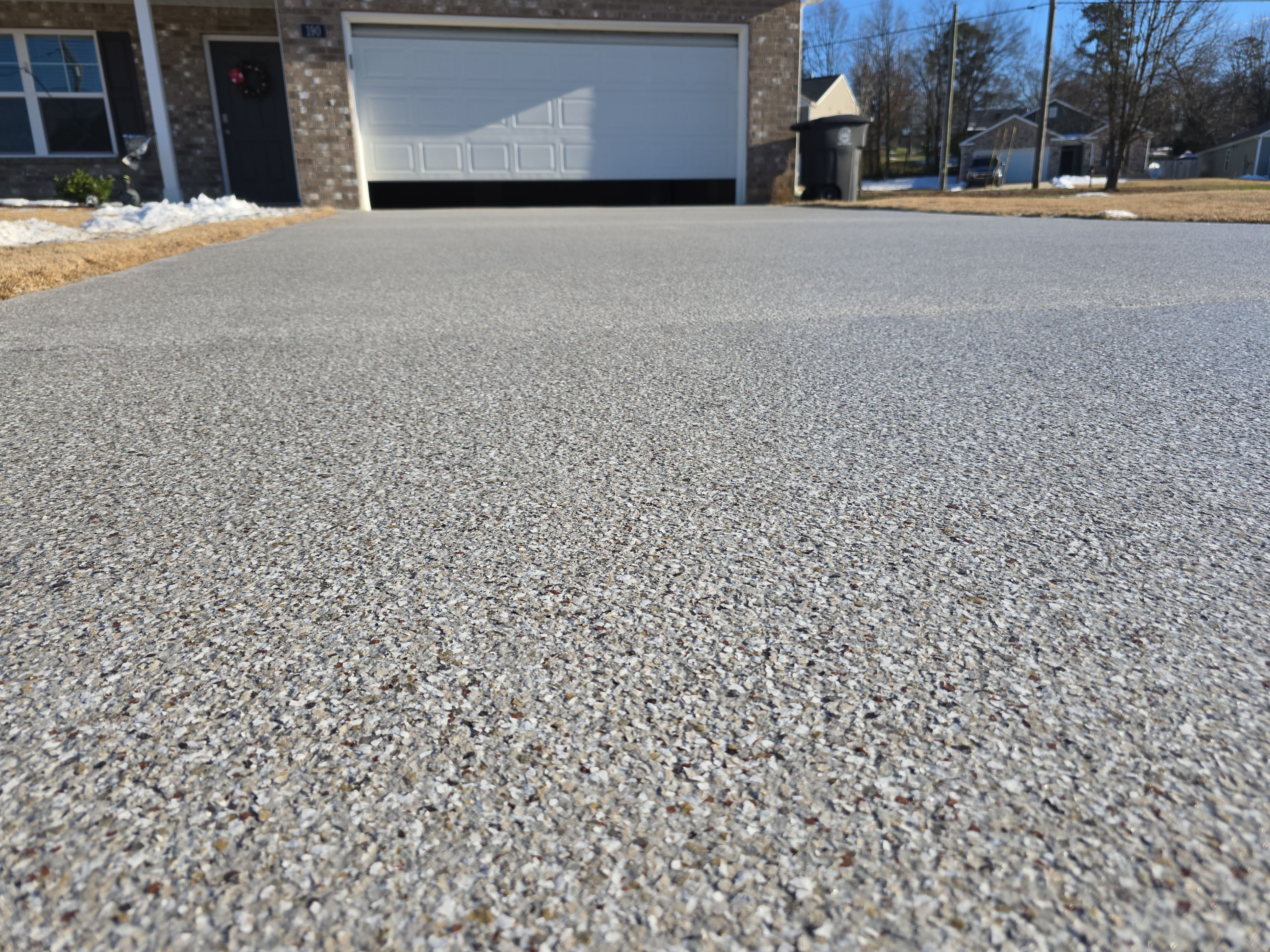 Driveway, Garage, & Front Porch using Creekbed by Elite Floor Solutions