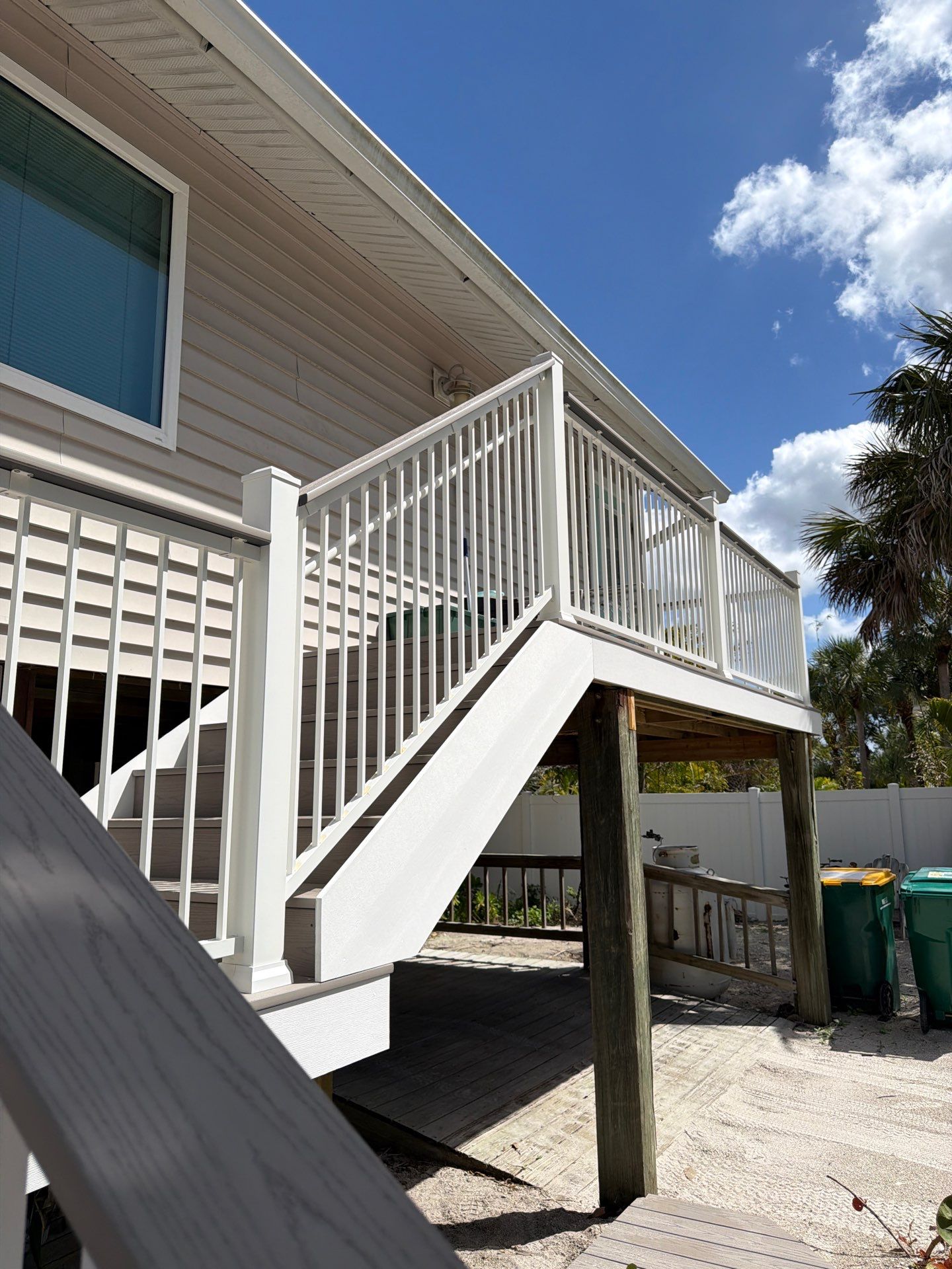 Elevated Home Deck Reconstruction With White Aluminum Railings in Placida by Smirnov Construction Inc