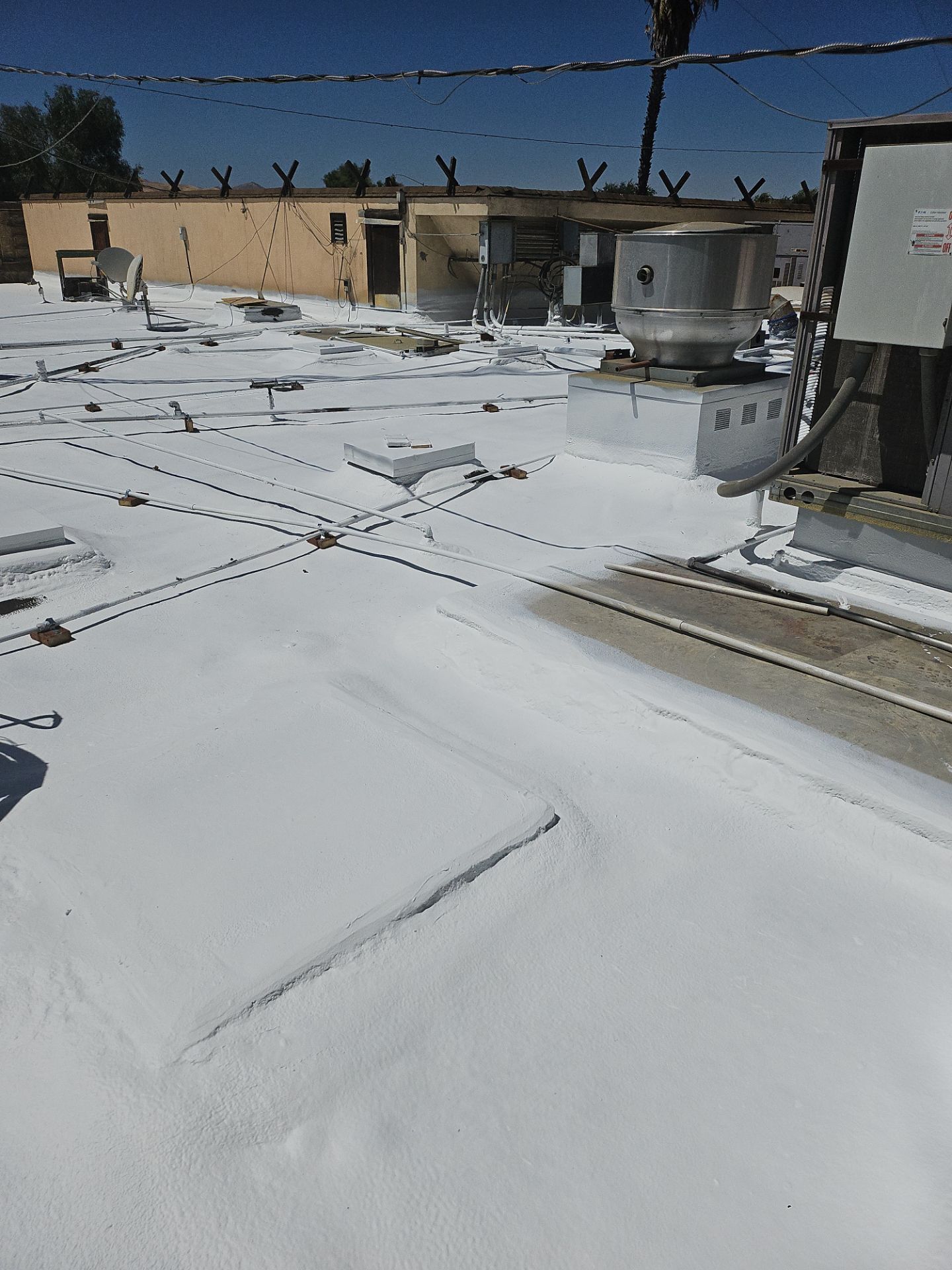 Spray foam and coatings using General Coatings acrylic coatings and spray foam by Straight Edge Roofing Inc