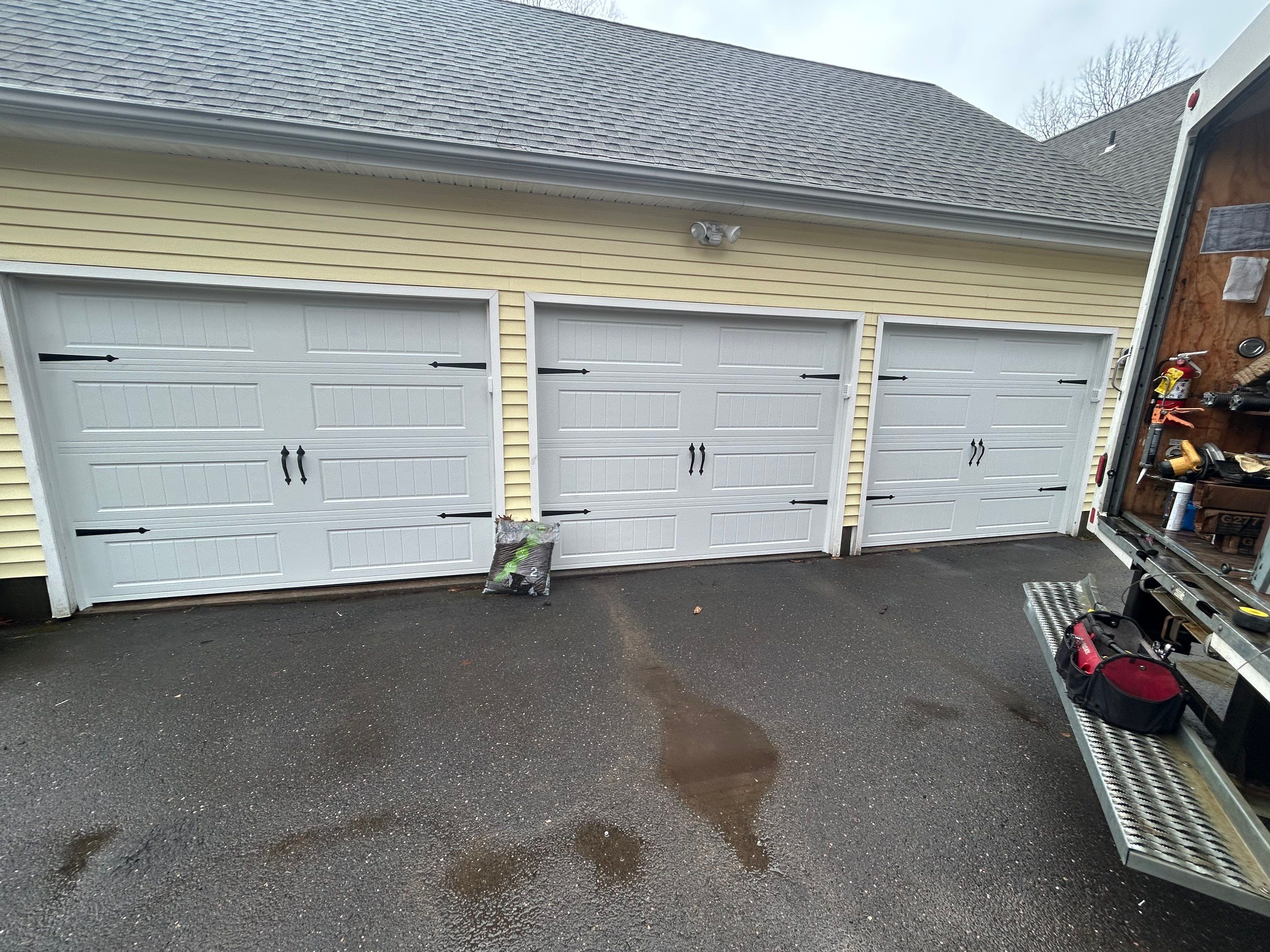 Modern Triple Garage Door Upgrade by DiGiorgi Roofing and Siding Inc