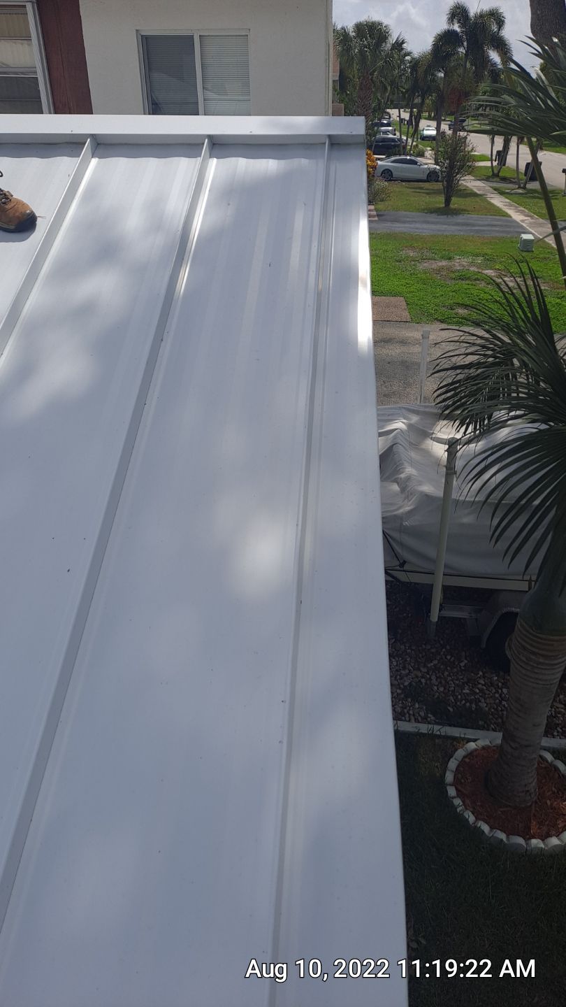 Residential Roofing Installation using 1.5" Nail Strip 24ga Solar White Kynar Coated Standing Seam Metal Panels by Morton Roofing, Inc.