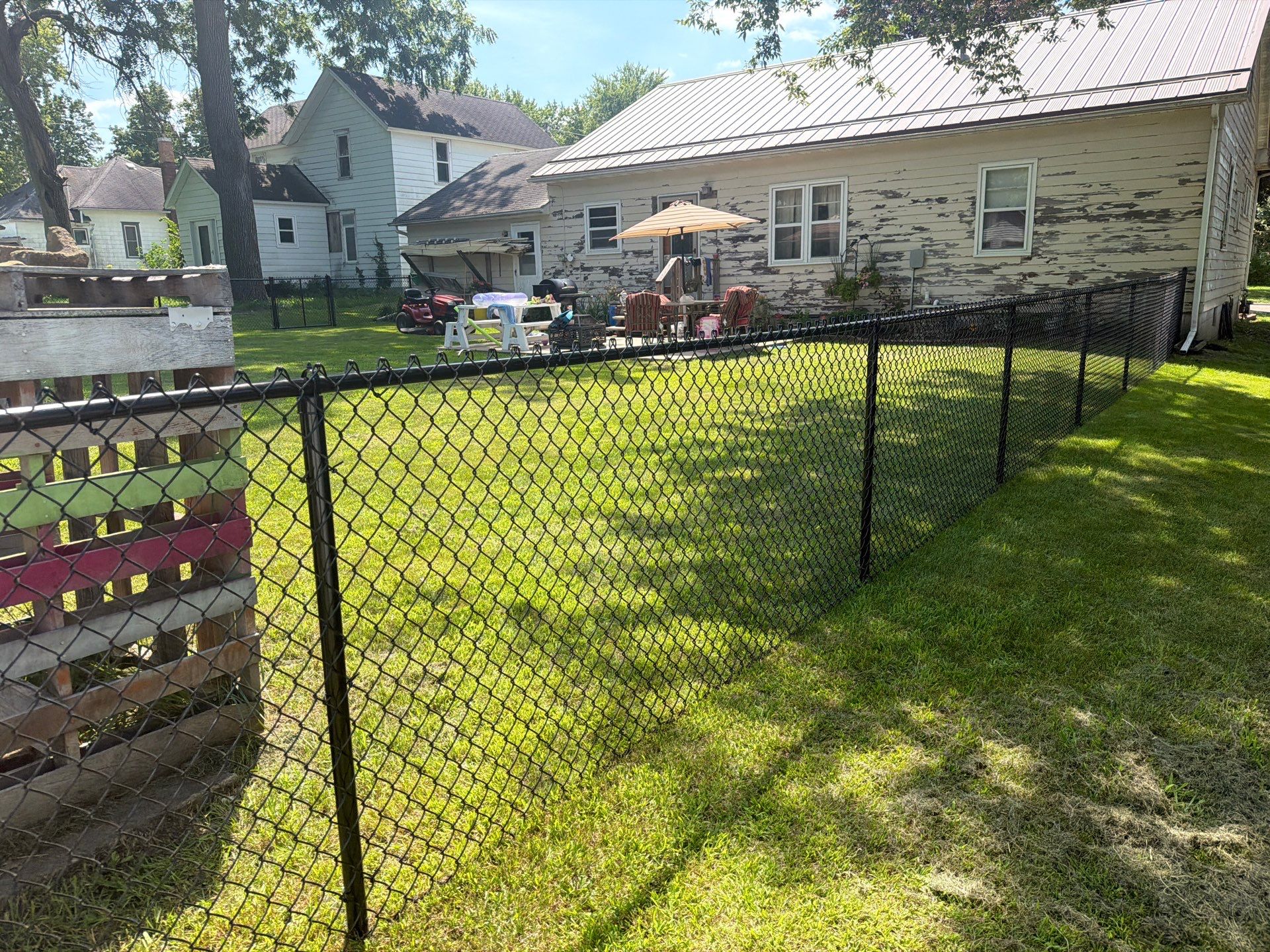 Black Chain Link Backyard Fence Installation in Tripoli, IA by Perfect Picket Fence and Stain