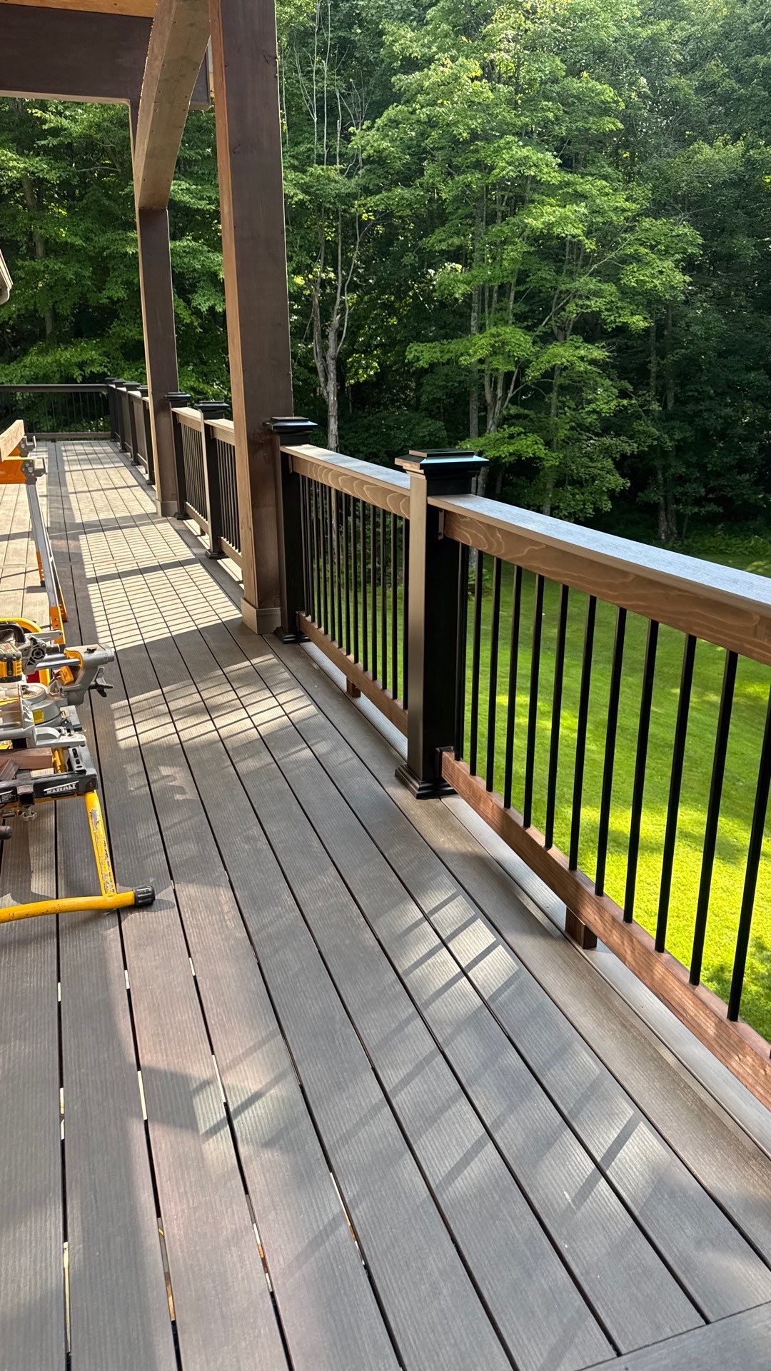 Custom Composite Deck Construction with Stone Pillars in Fayetteville by Walnut Hollow Decks & Outdoor Living