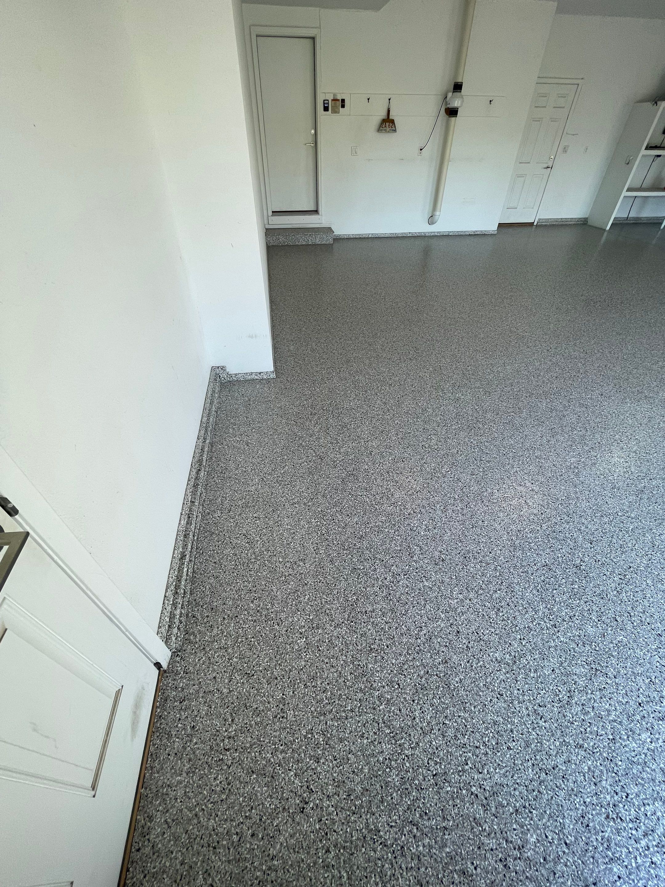Yankton Garage Floor Restoration with Gray Speckled Epoxy Coating by Select Painting, Coatings & Garage Cabinets