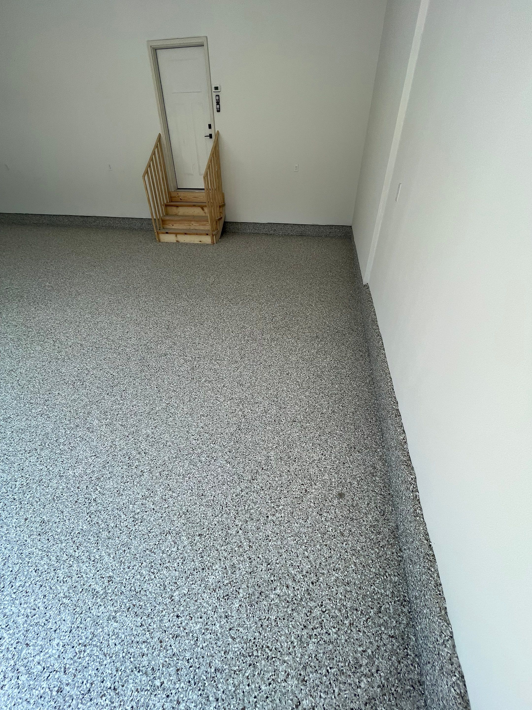 Grey Speckled Garage Floor Coating in Sioux Falls by Select Painting, Coatings & Garage Cabinets