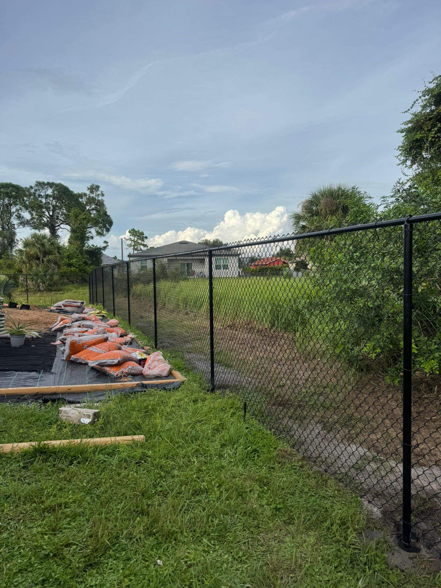 Black Vinyl-Coated Chain Link Fence and Gate Installation in North Port by True Fence LLC