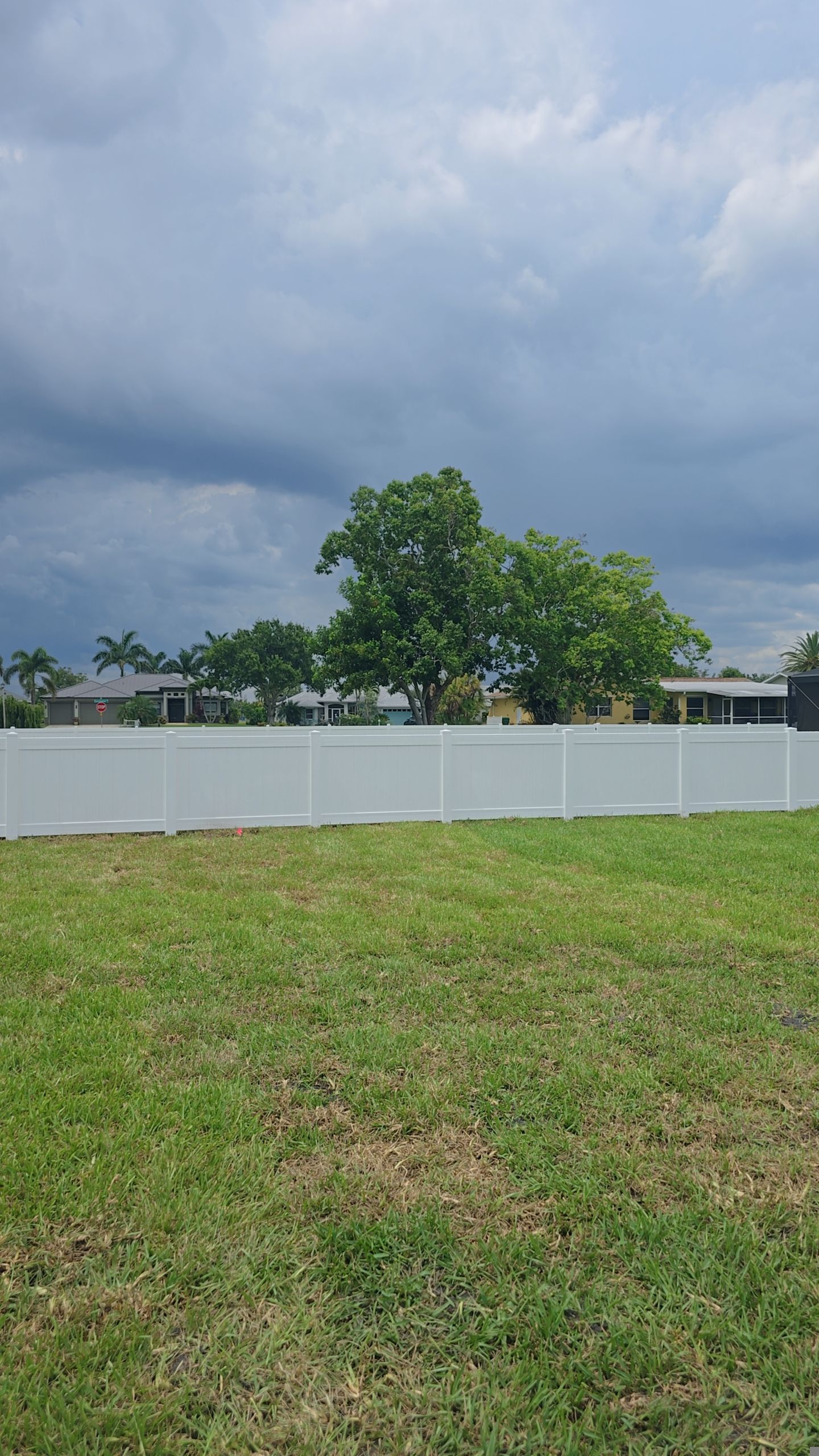 White Vinyl Privacy Fence Installation on Port Charlotte Corner Lot by True Fence LLC
