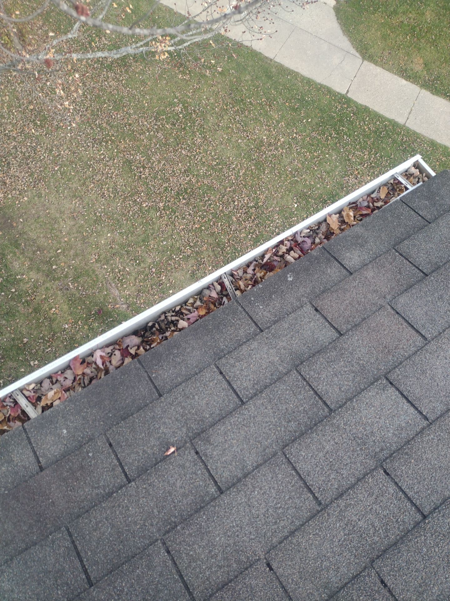 Commercial gutter cleaning Lansing before photo with filled gutters