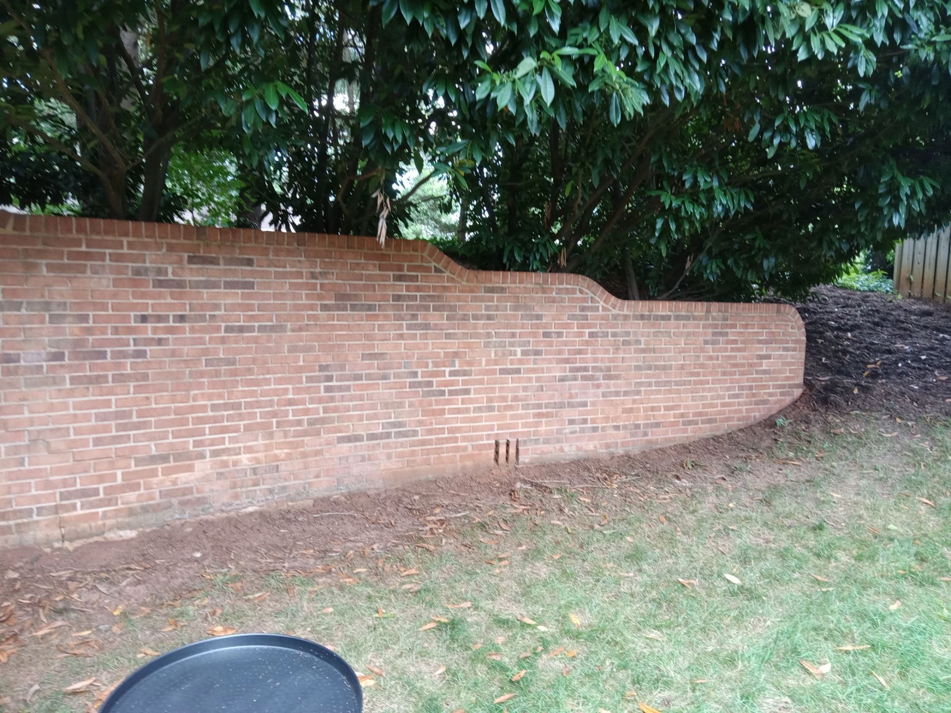 pressure washing brick wall to remove dirt buildup and stains restoring appearance