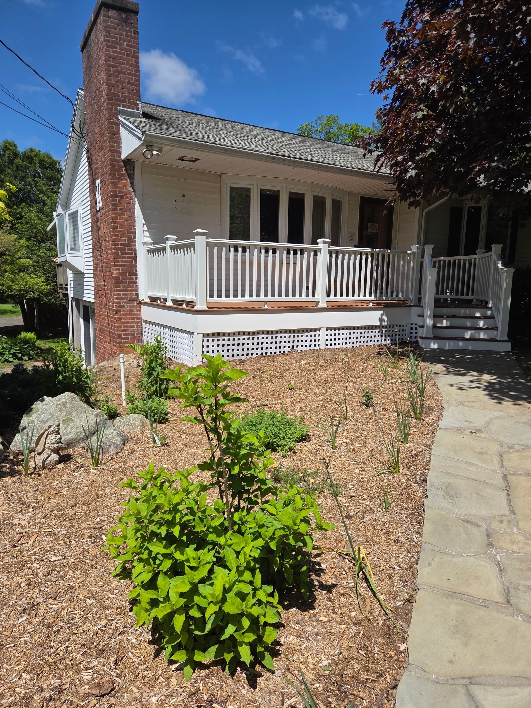 Deck Replacement, Trex Tiki torch boards, with White composite railing and lattice. by DiGiorgi Roofing and Siding Inc